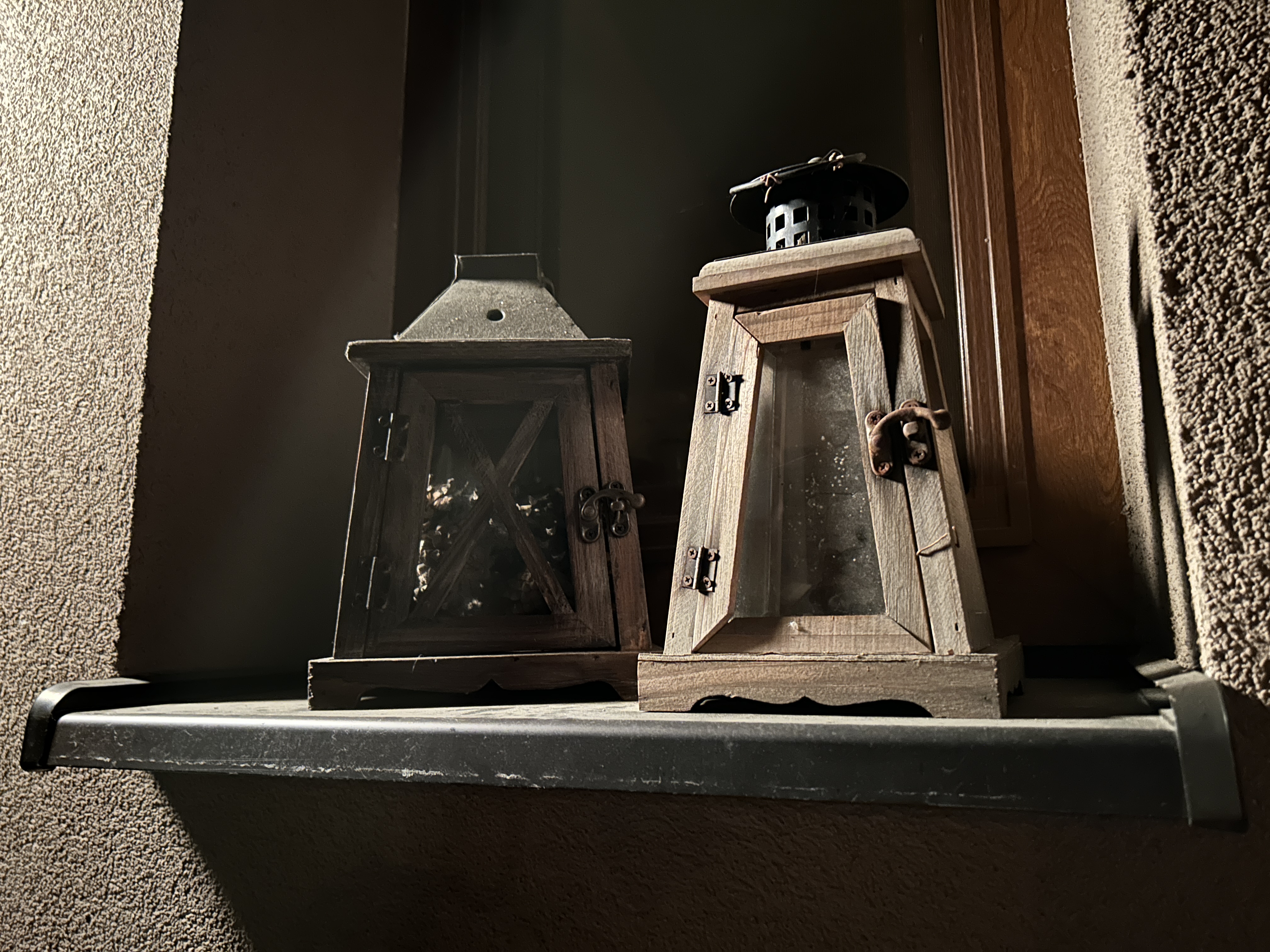 two wooden lanterns on shelf