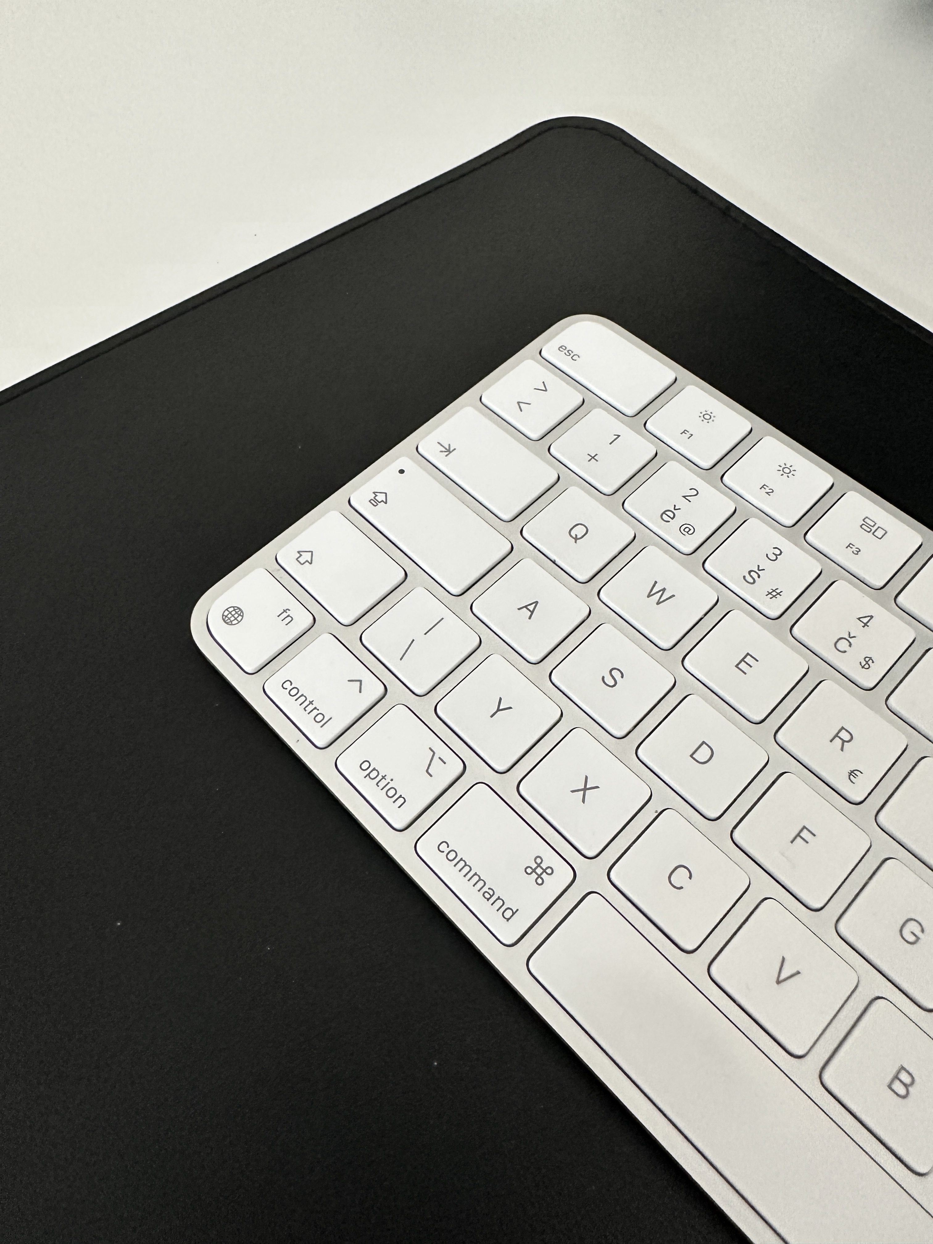white keyboard on black desk