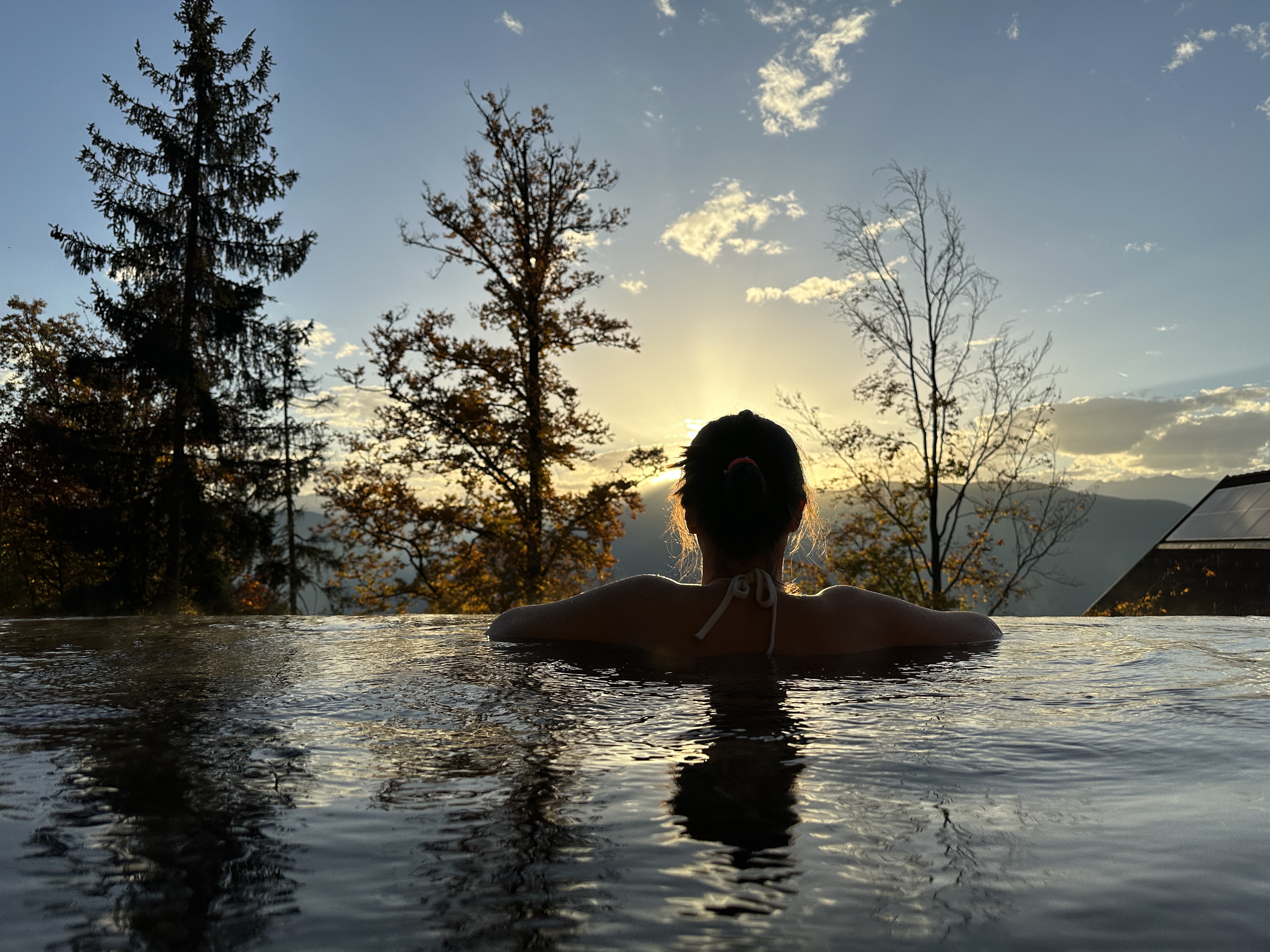 person infinity pool sunset
