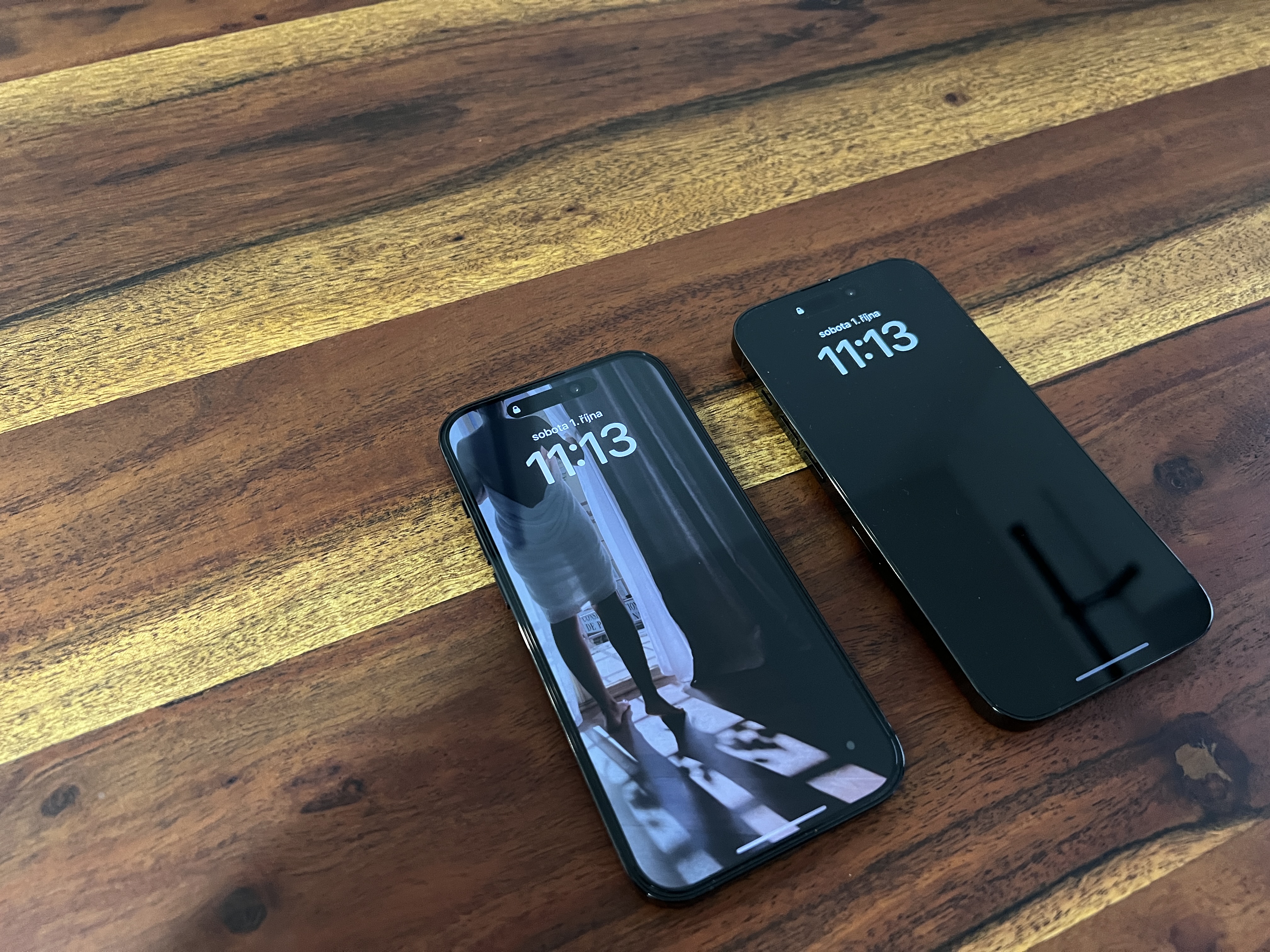 two iphones on wooden table