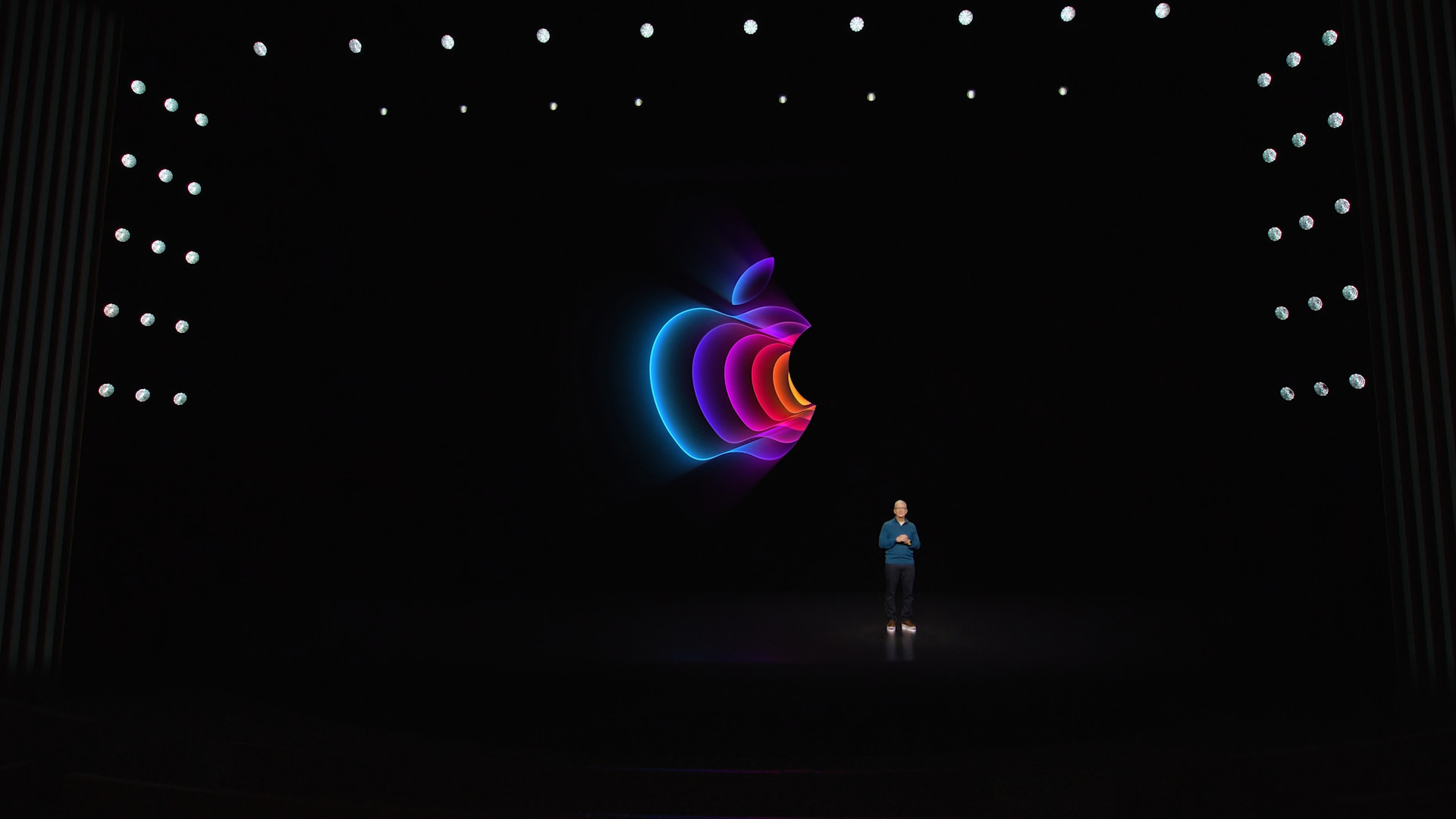 person on stage with apple logo