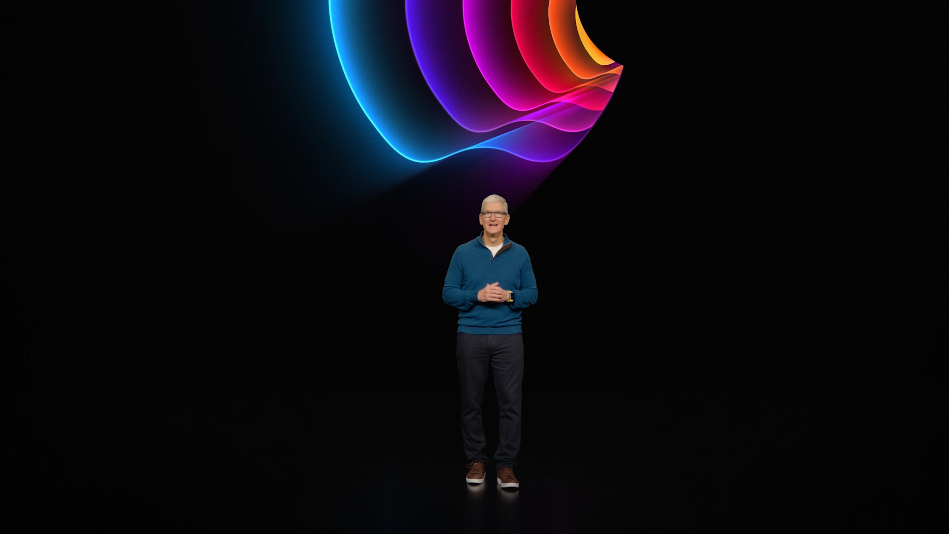 person on stage with colorful background