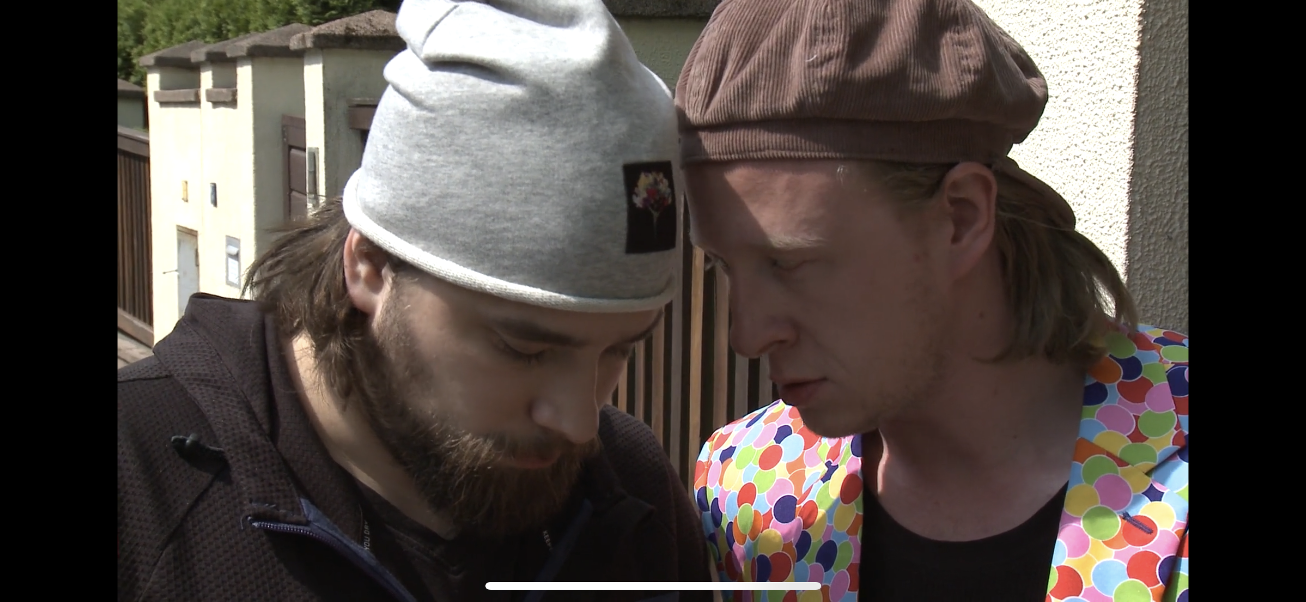 two men talking outside