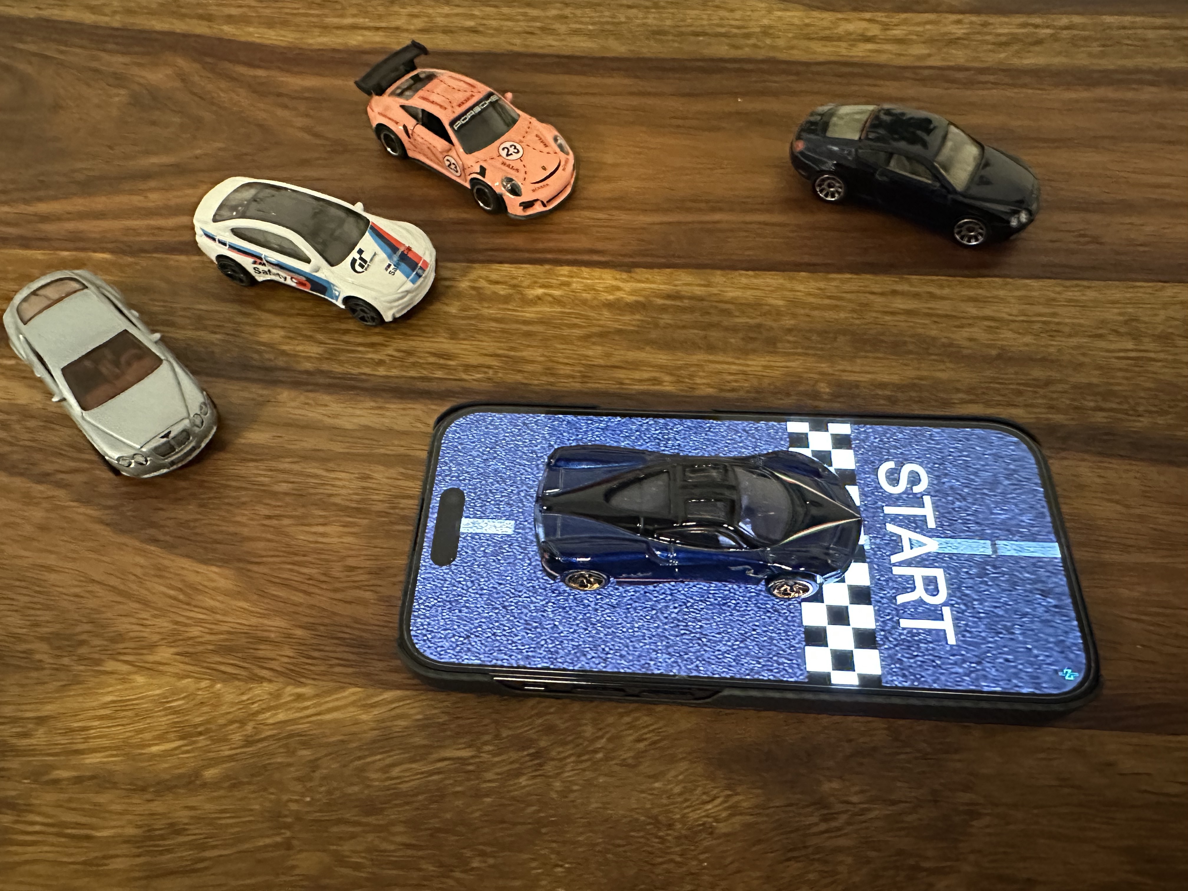 mini cars on phone checkered road