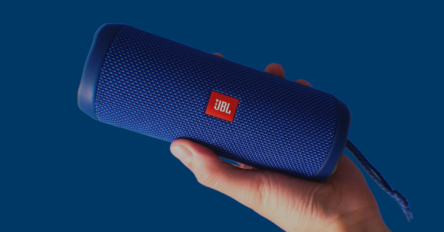 blue jbl speaker in hand