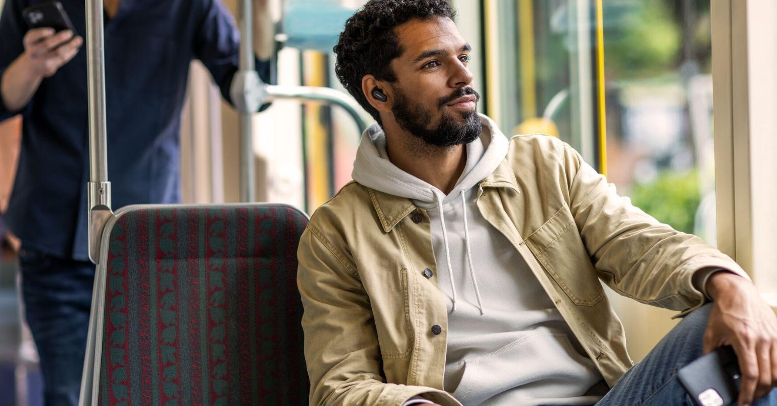 man wearing earbuds on bus