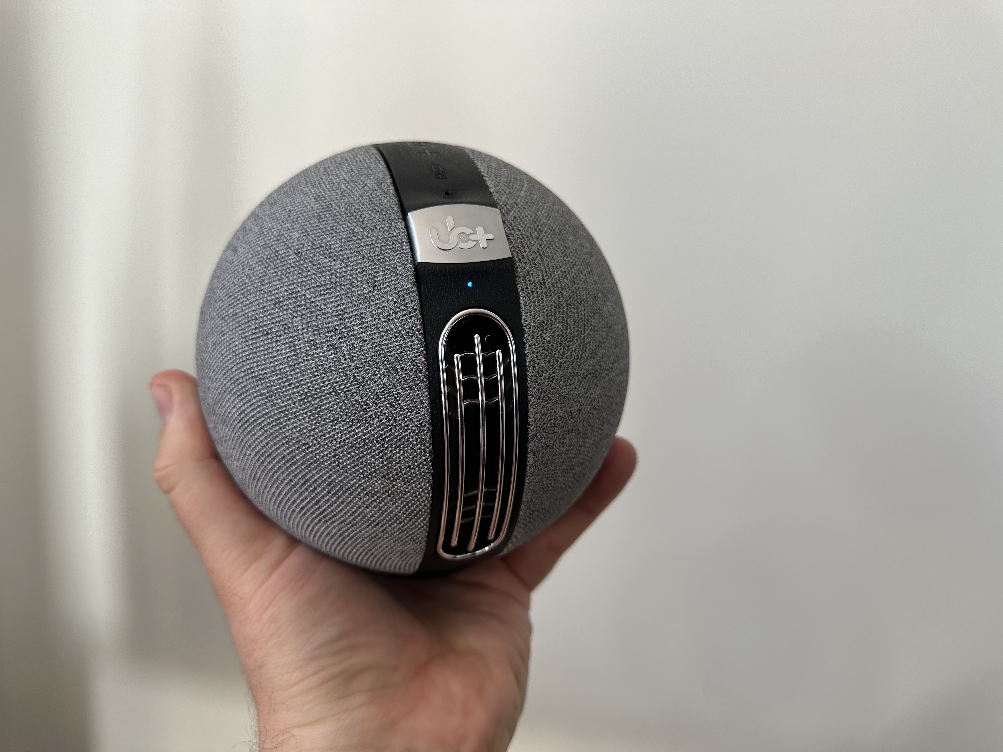 hand holding round speaker