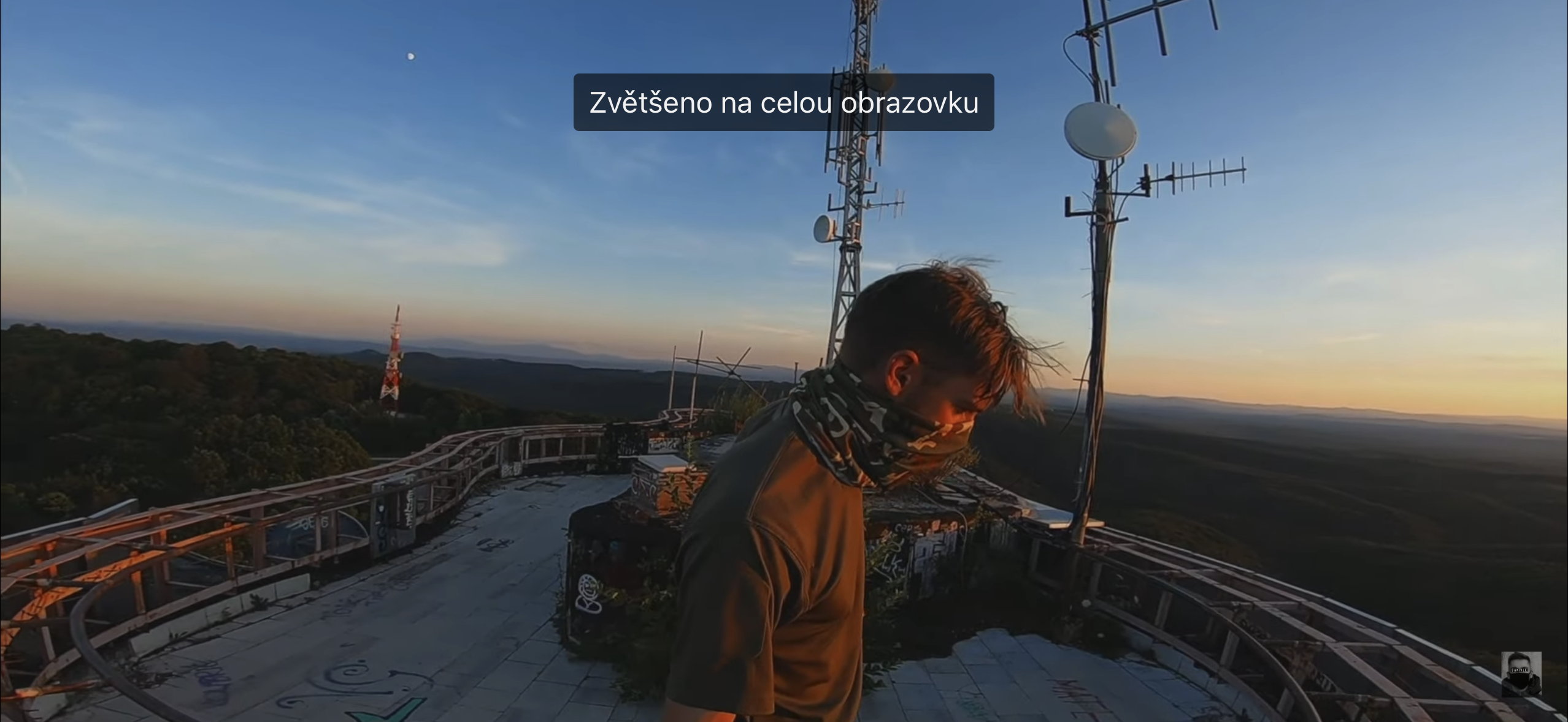 man on rooftop sunset