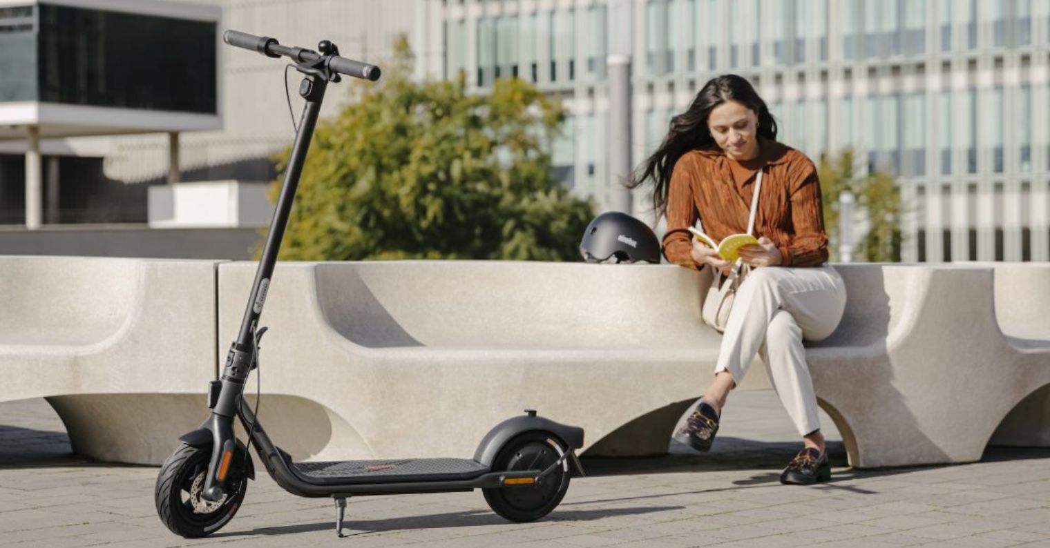 person sitting with electric scooter