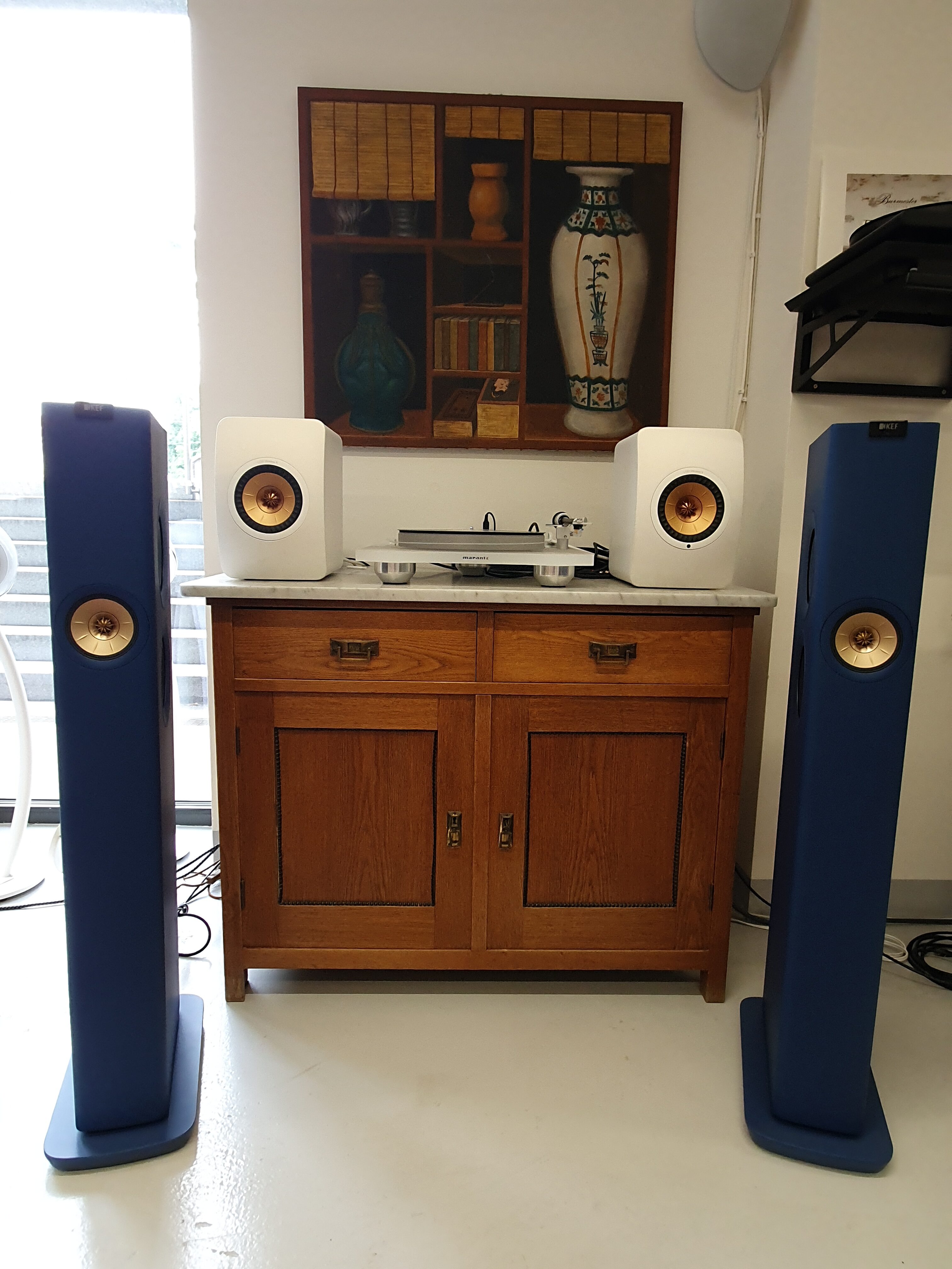 blue speakers with wooden cabinet
