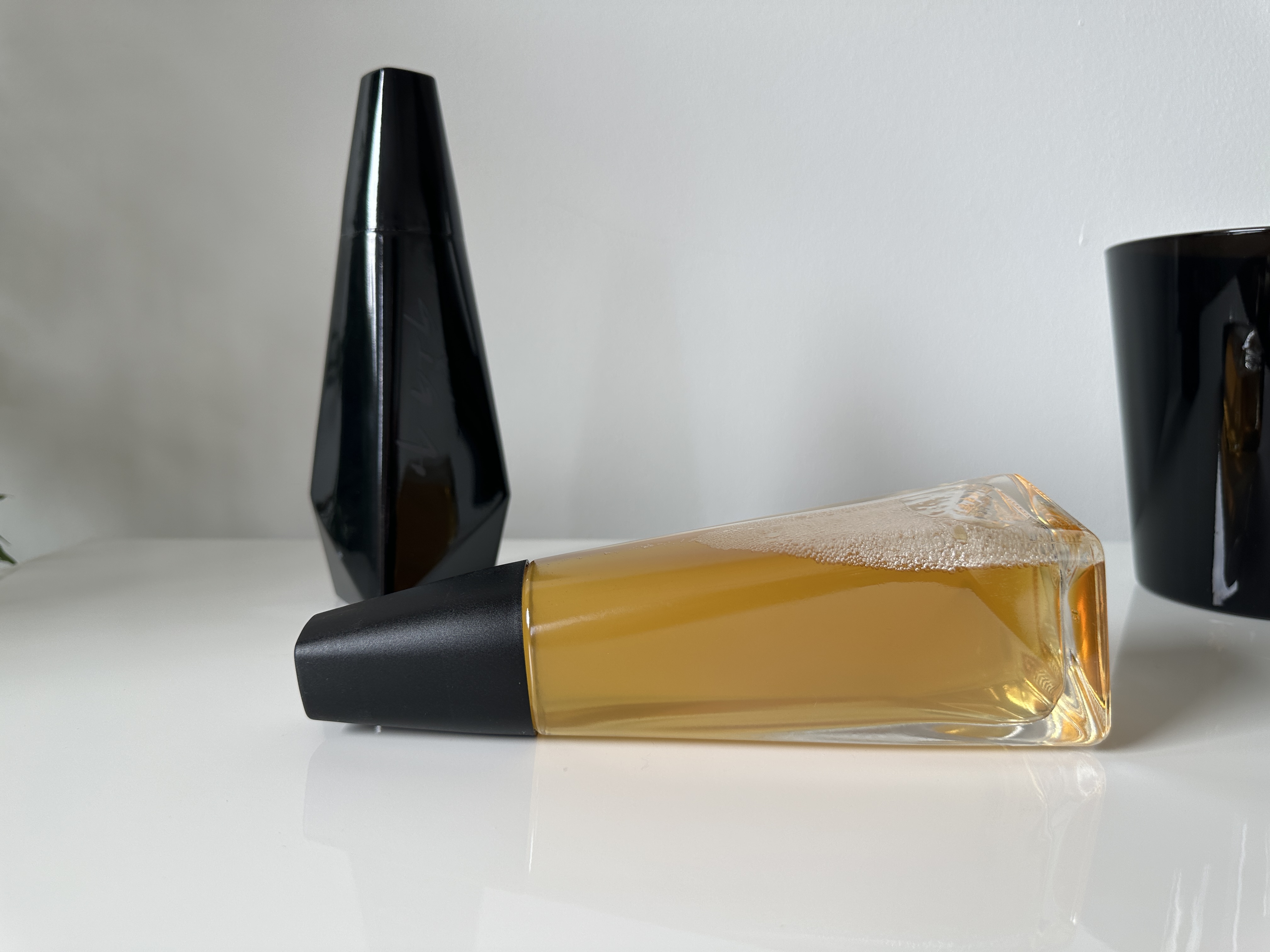 clear and black bottles on table