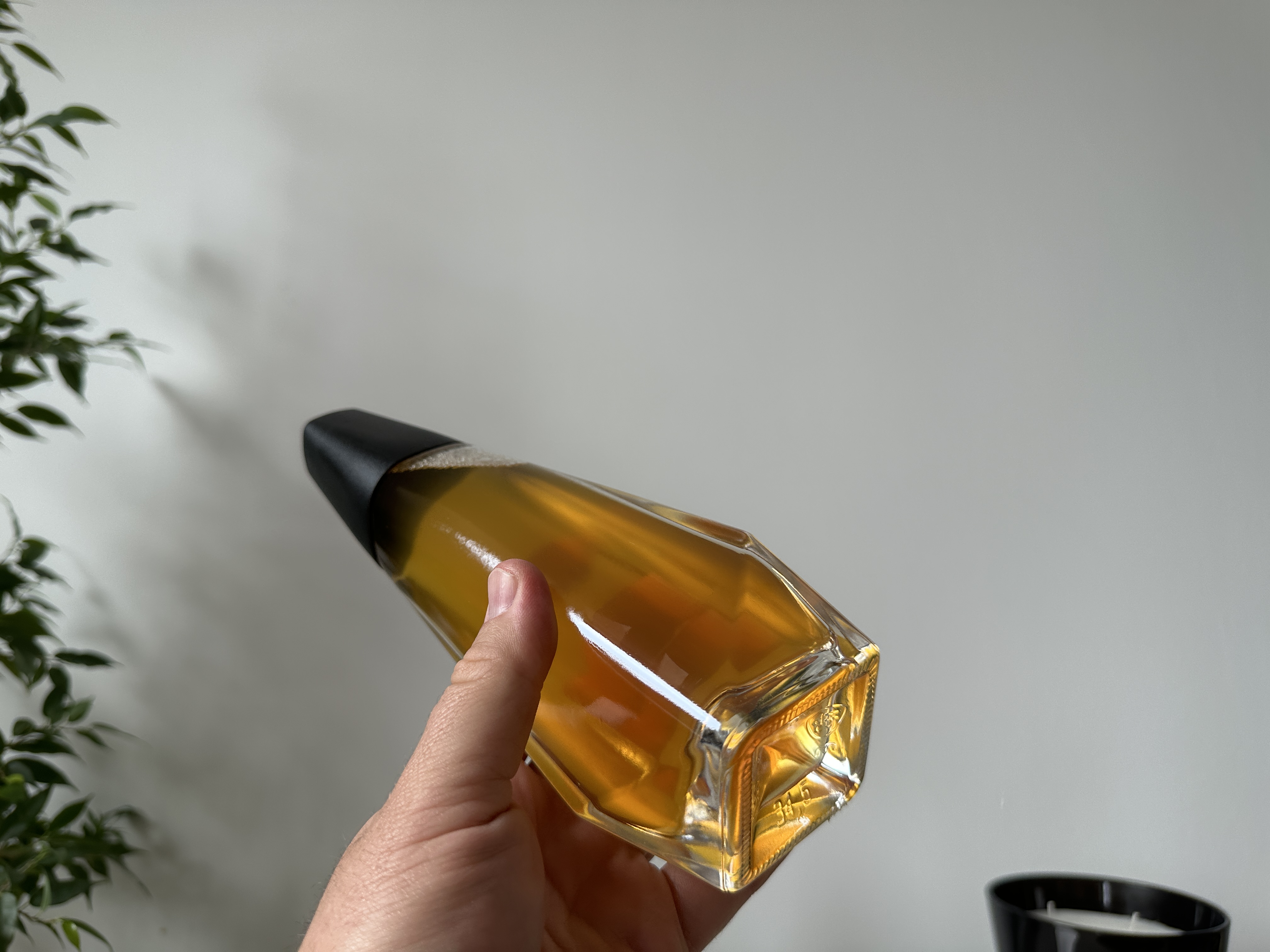 hand holding clear geometric bottle