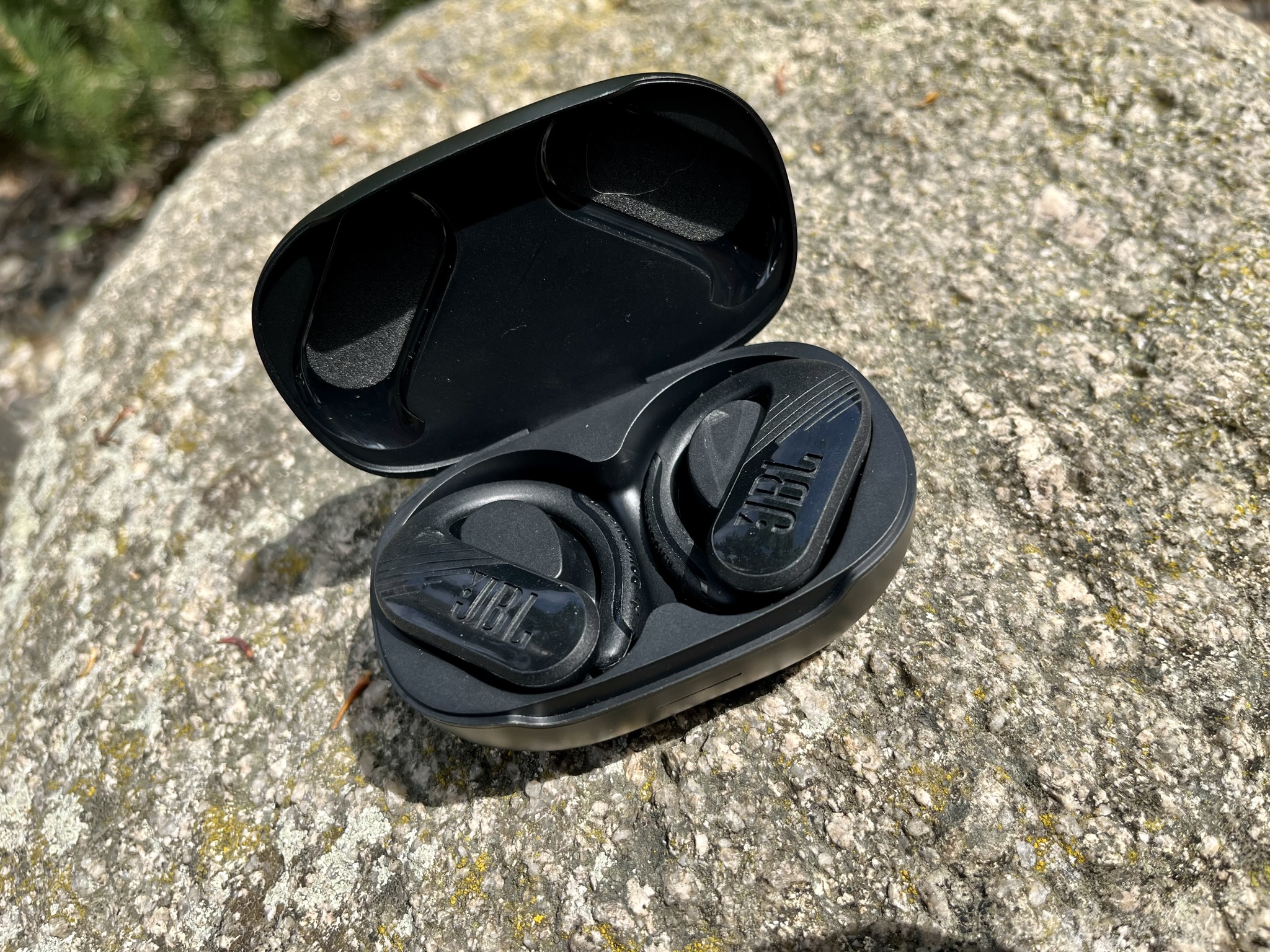 wireless earbuds on rock