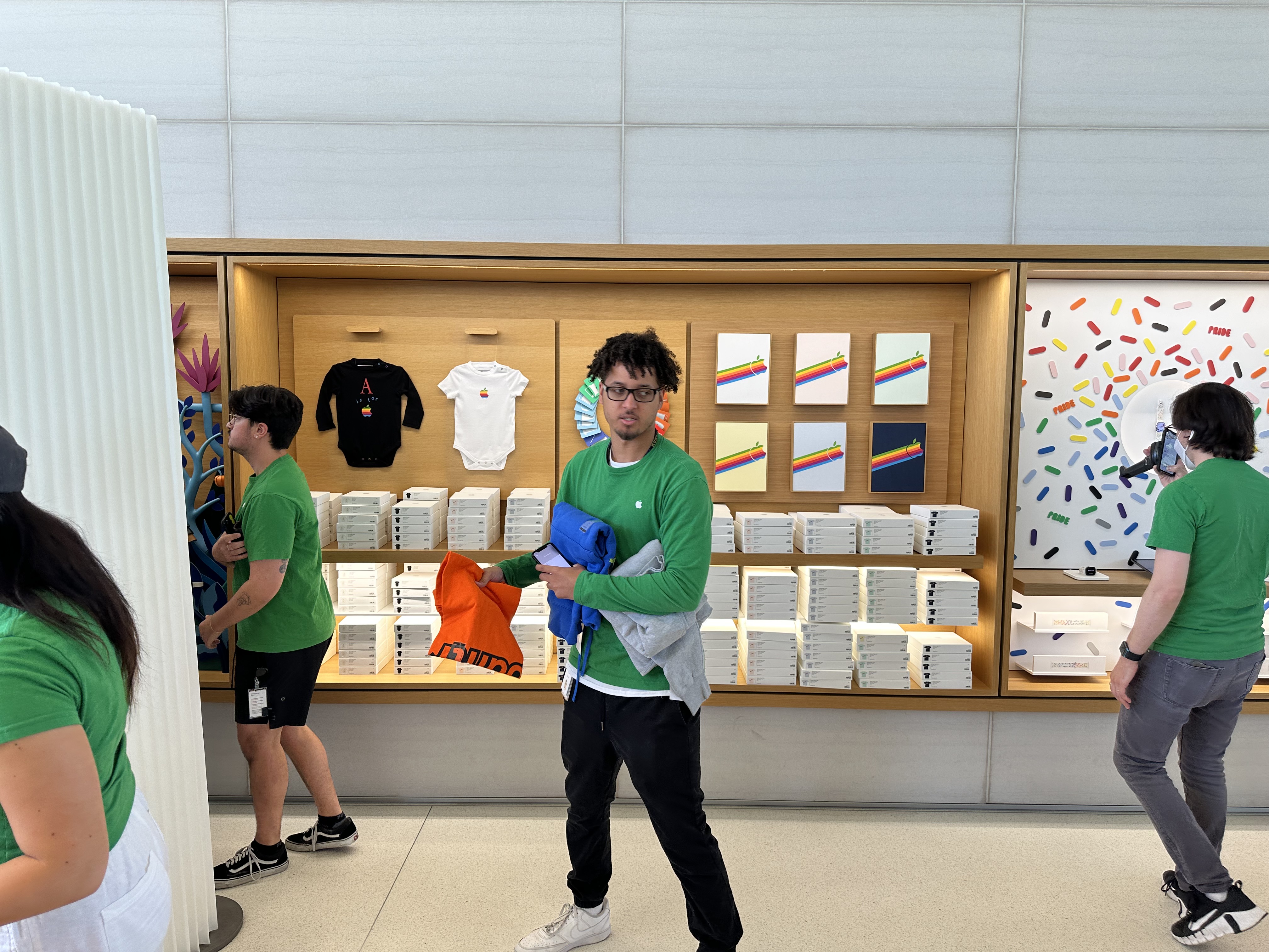man holding shirts in store