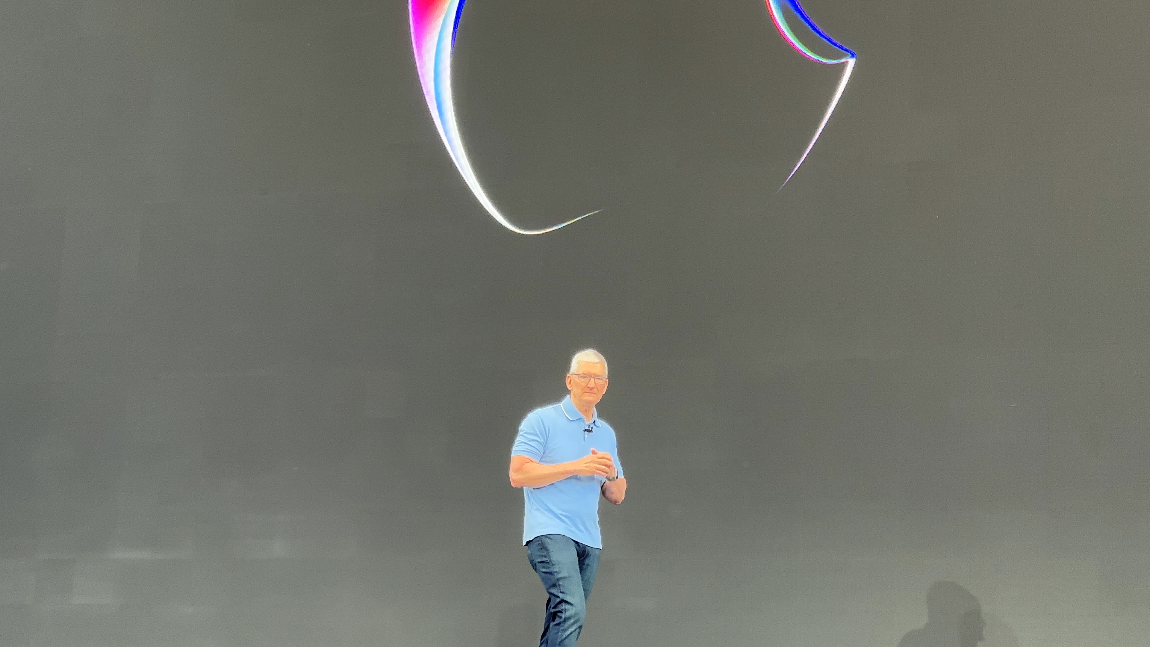 speaker on stage with logo