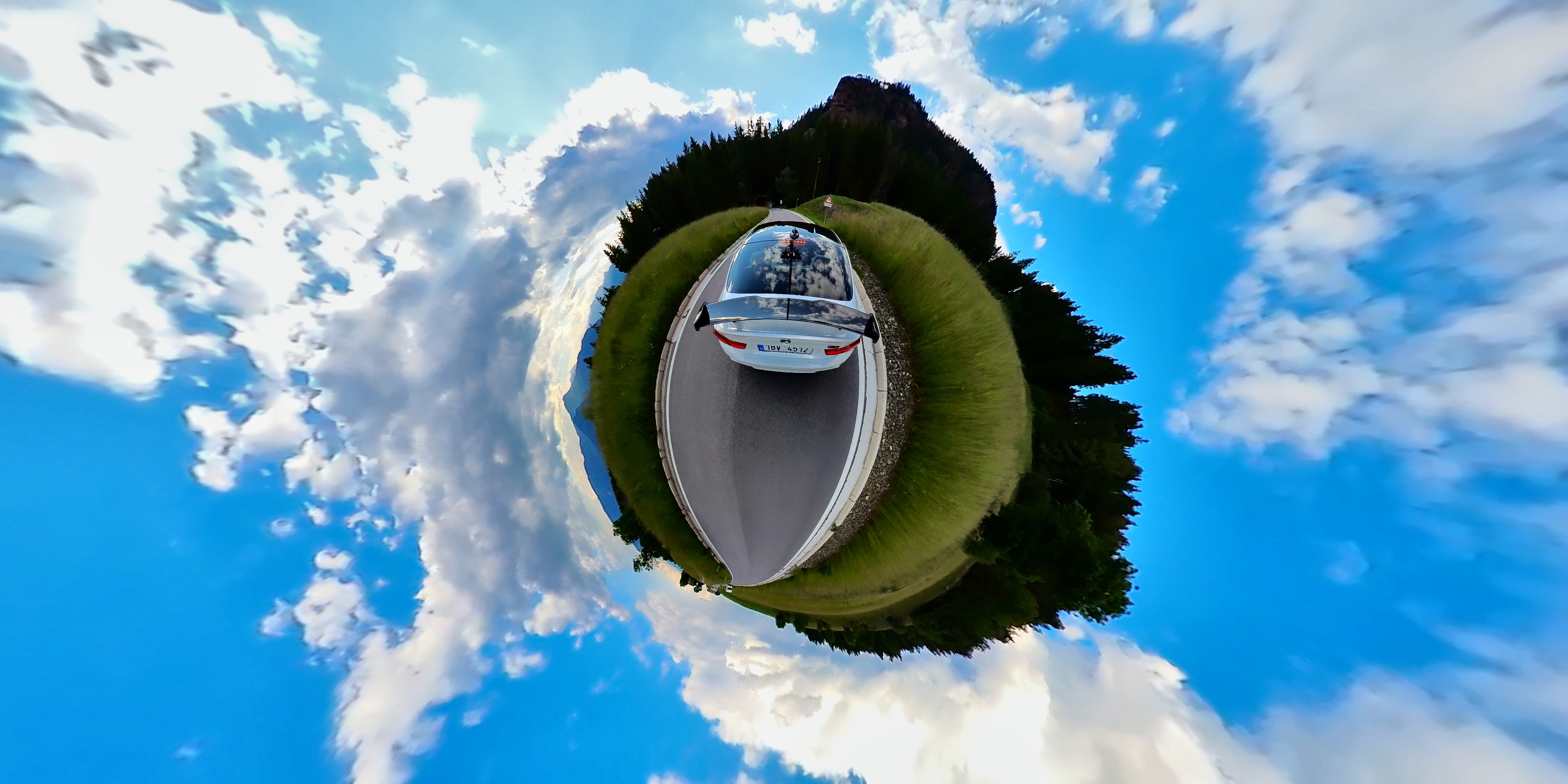 car on road tiny planet view