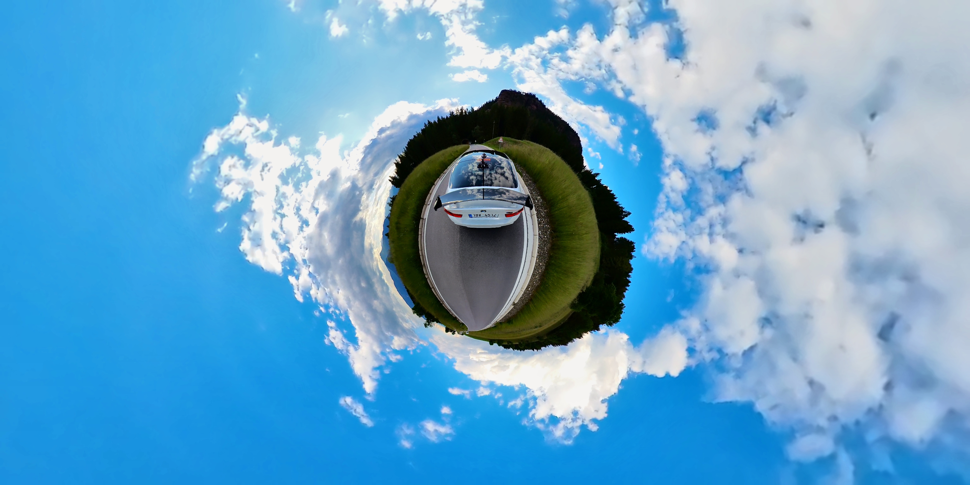 car on road tiny planet