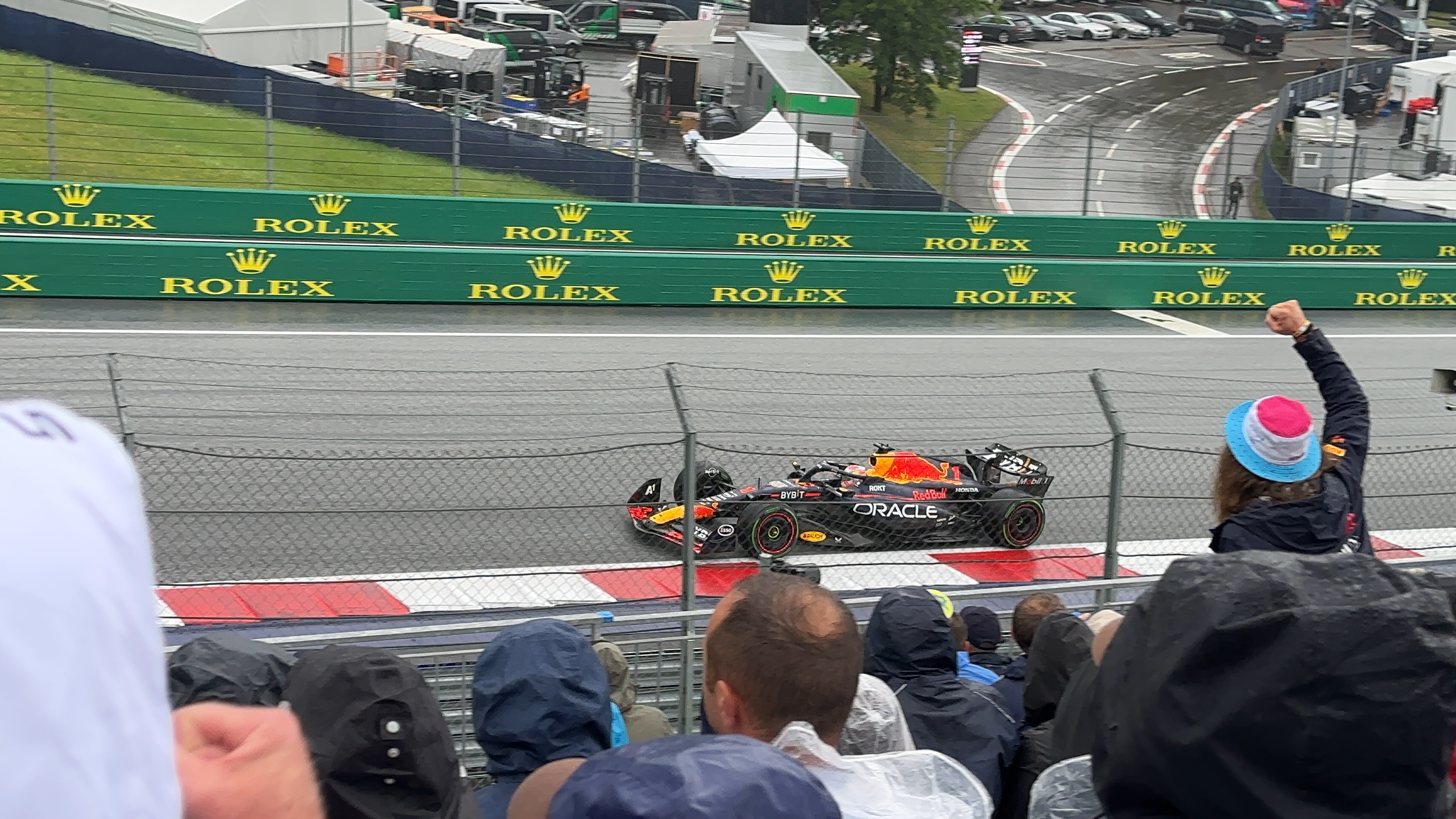 formula one car passing crowd