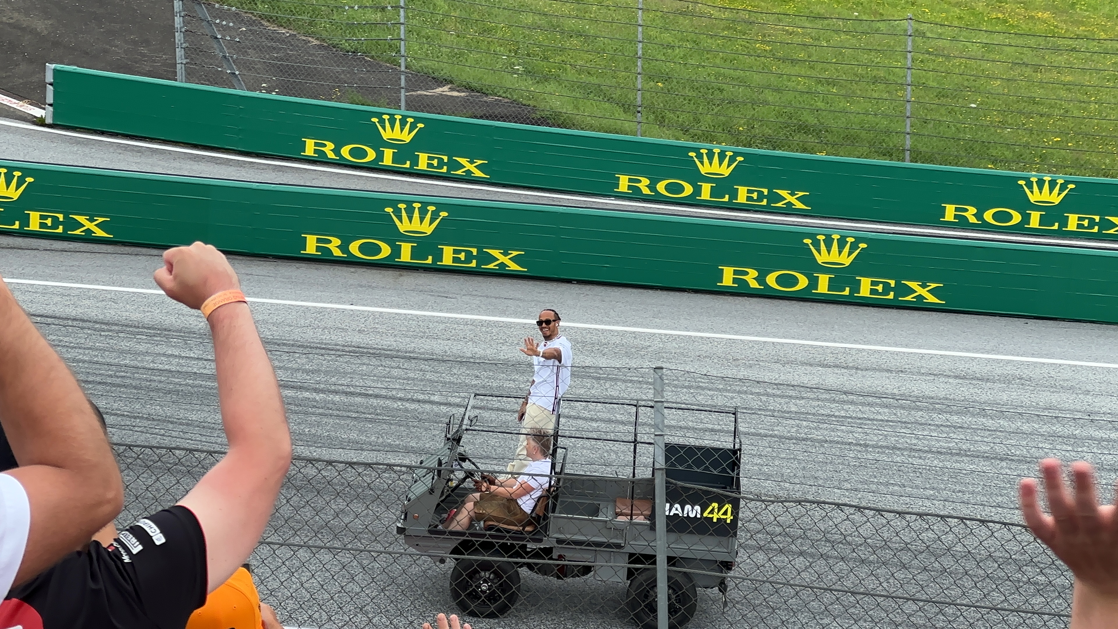 person waving from vehicle