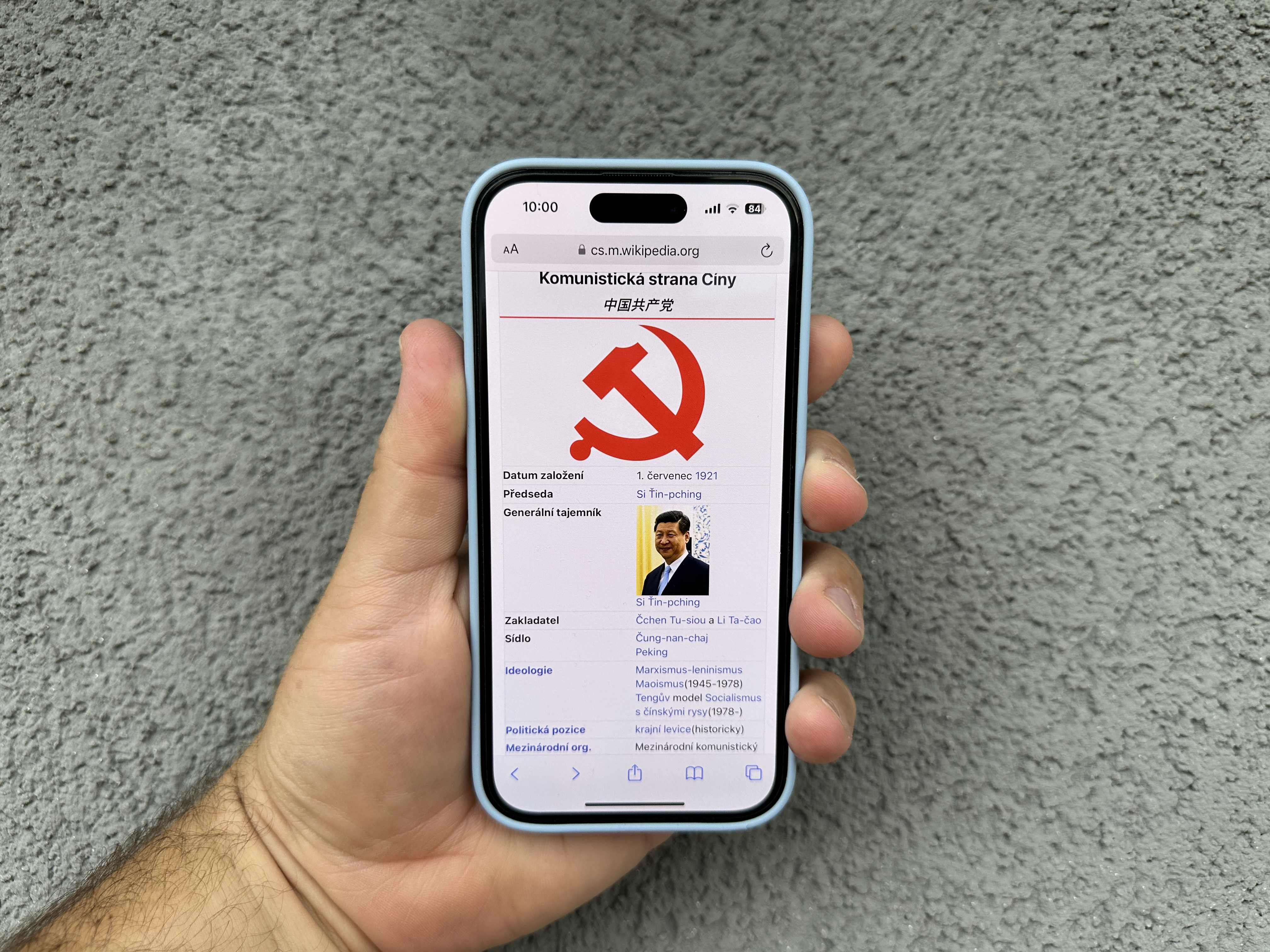 hand holding phone with website