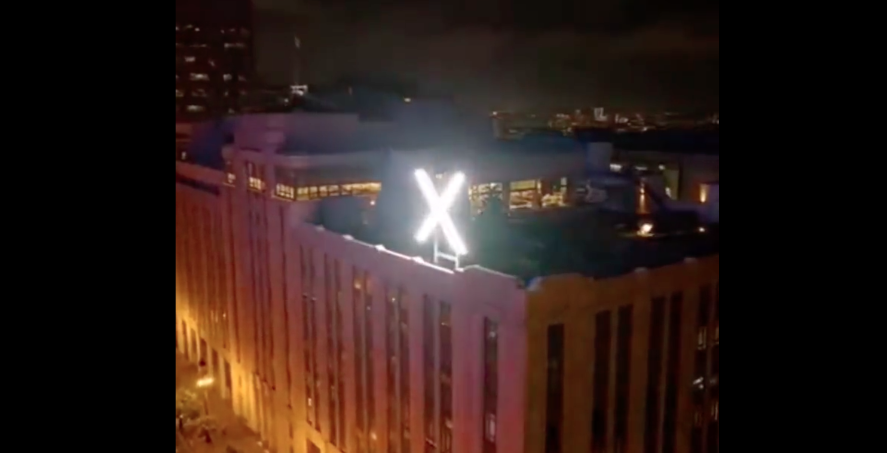 illuminated x sign on building