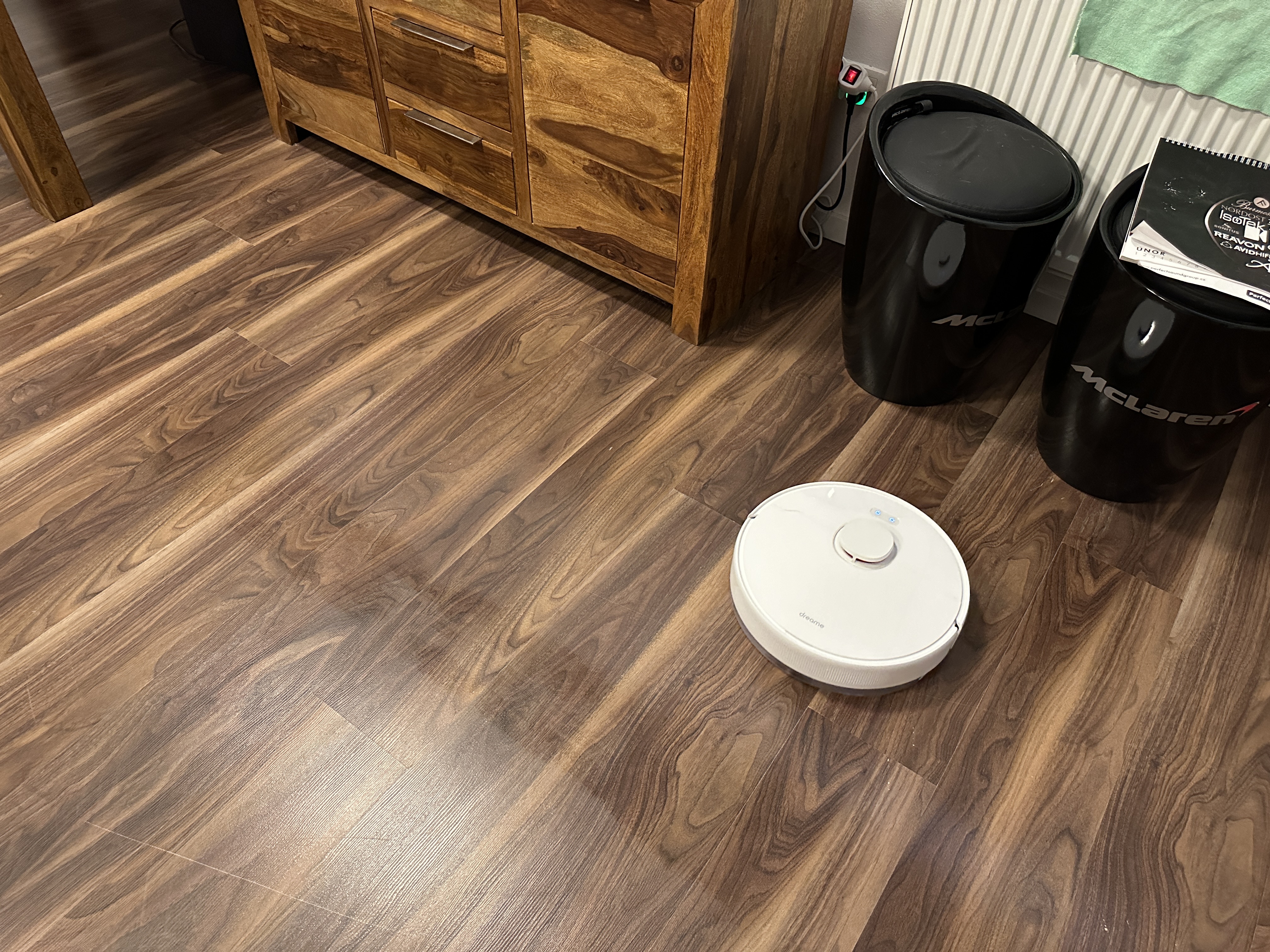 robot vacuum near cabinet