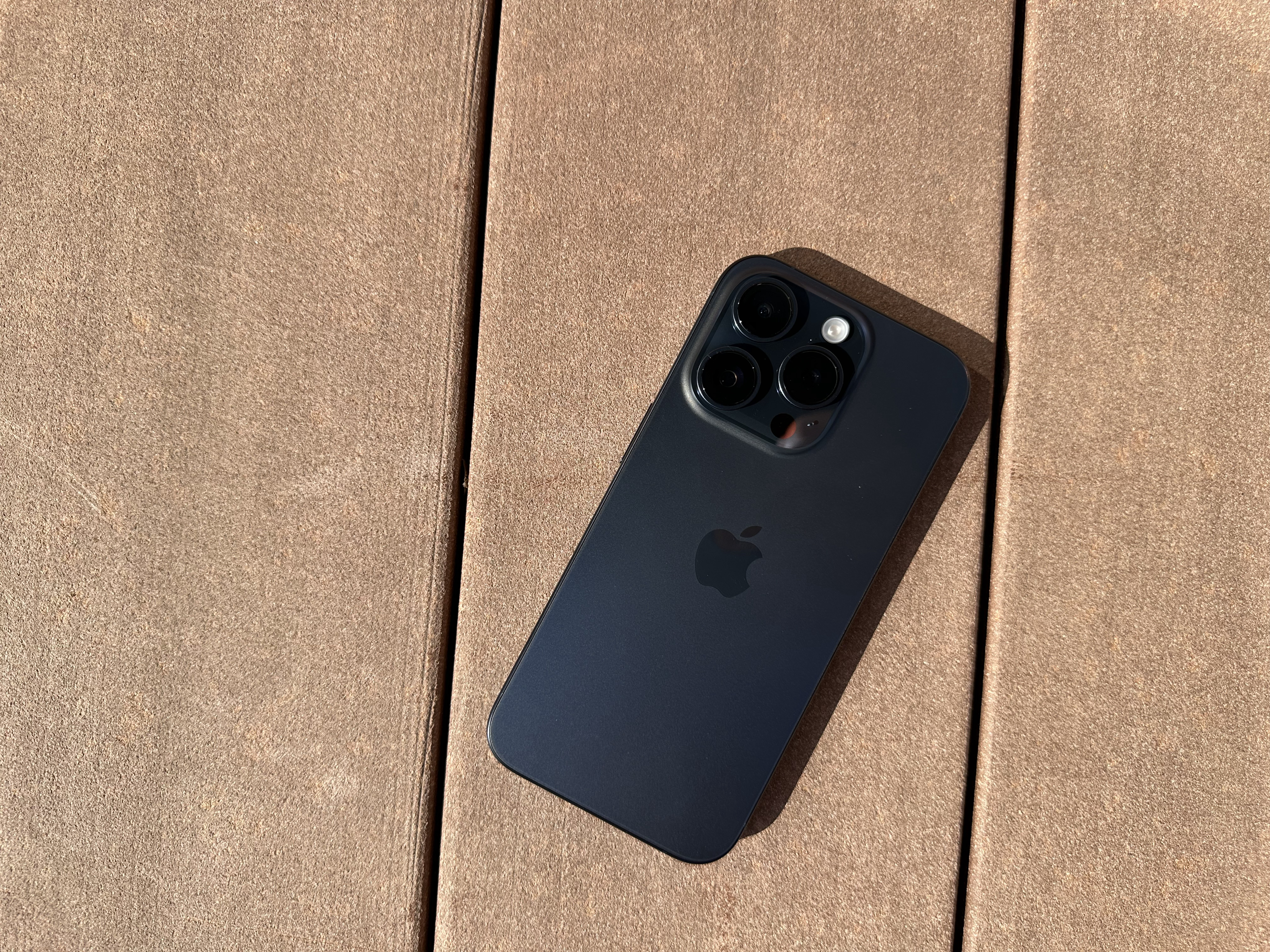 black smartphone on wood