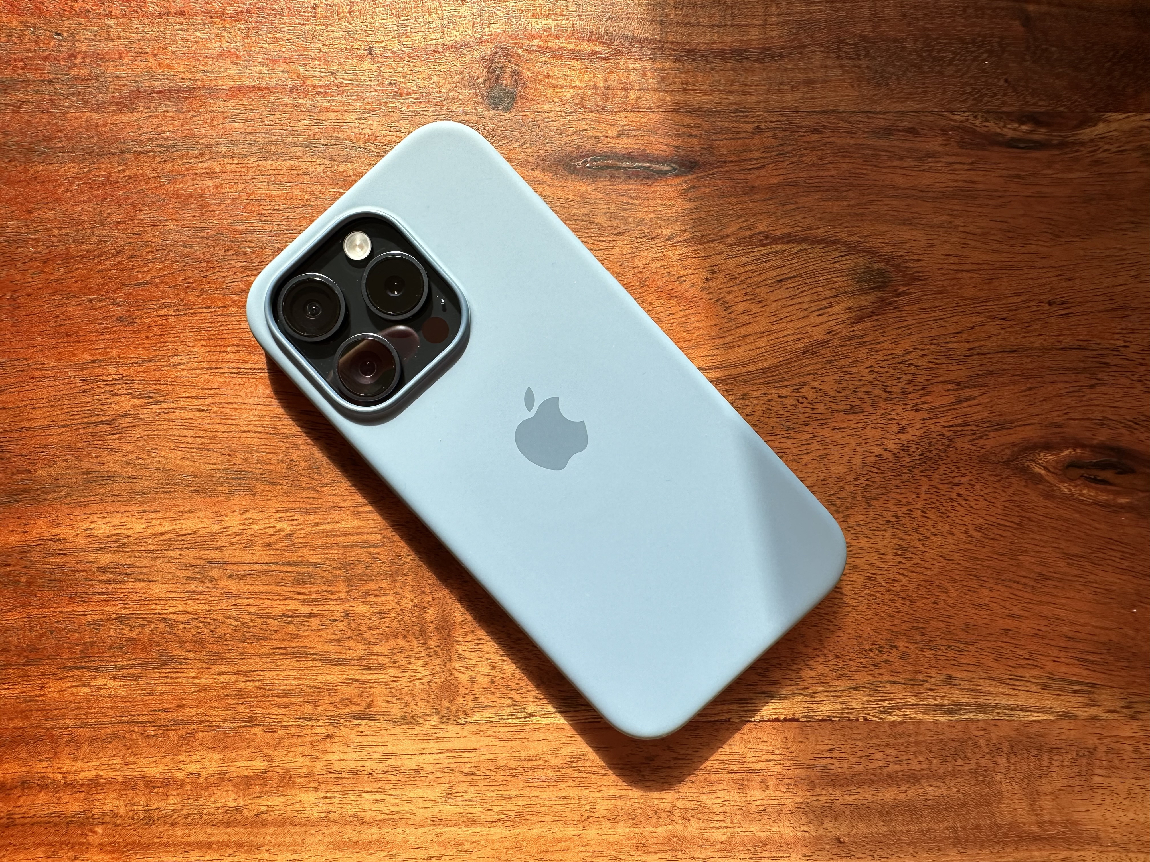 blue iphone on wooden table