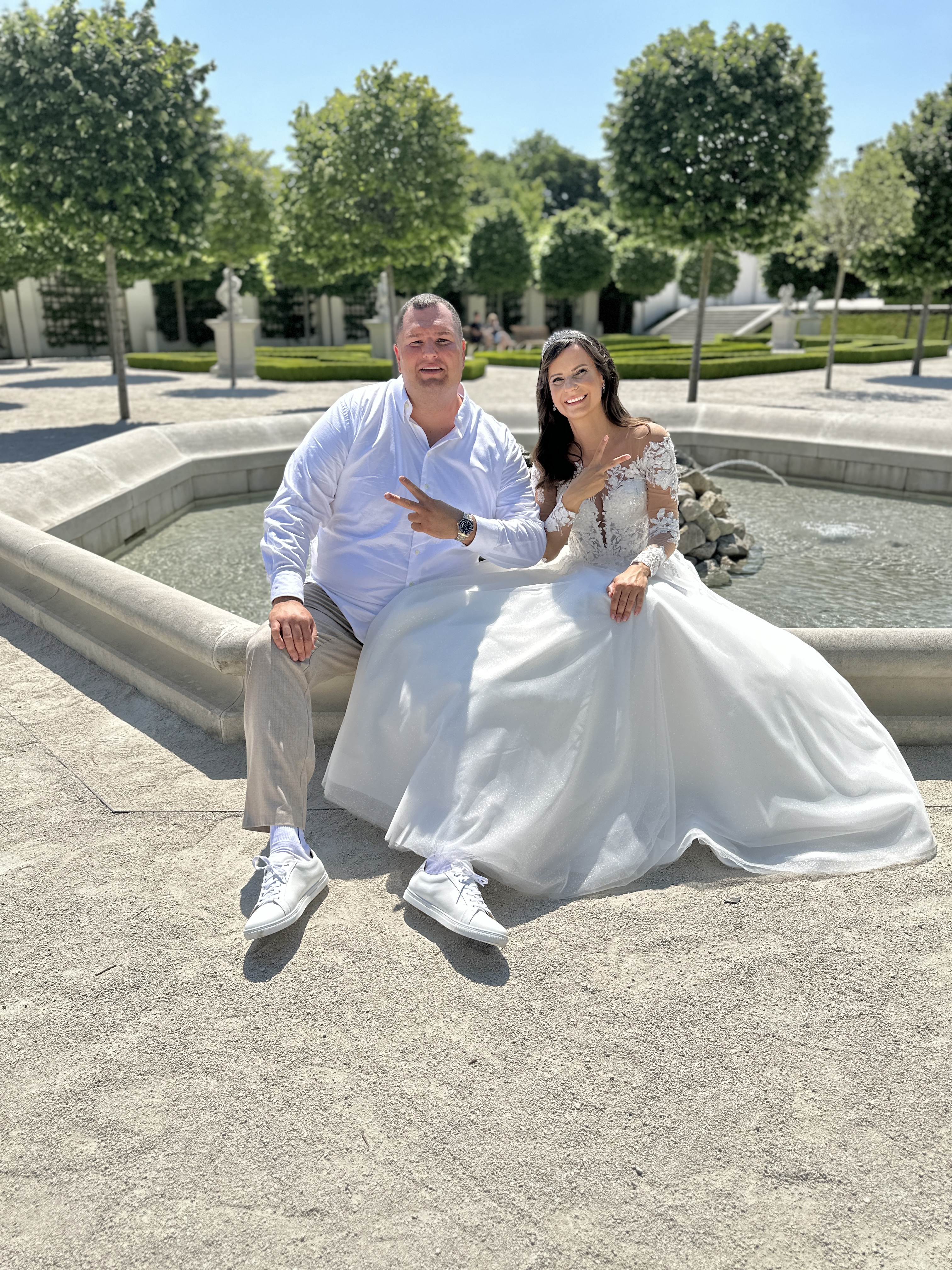 bride and groom by fountain