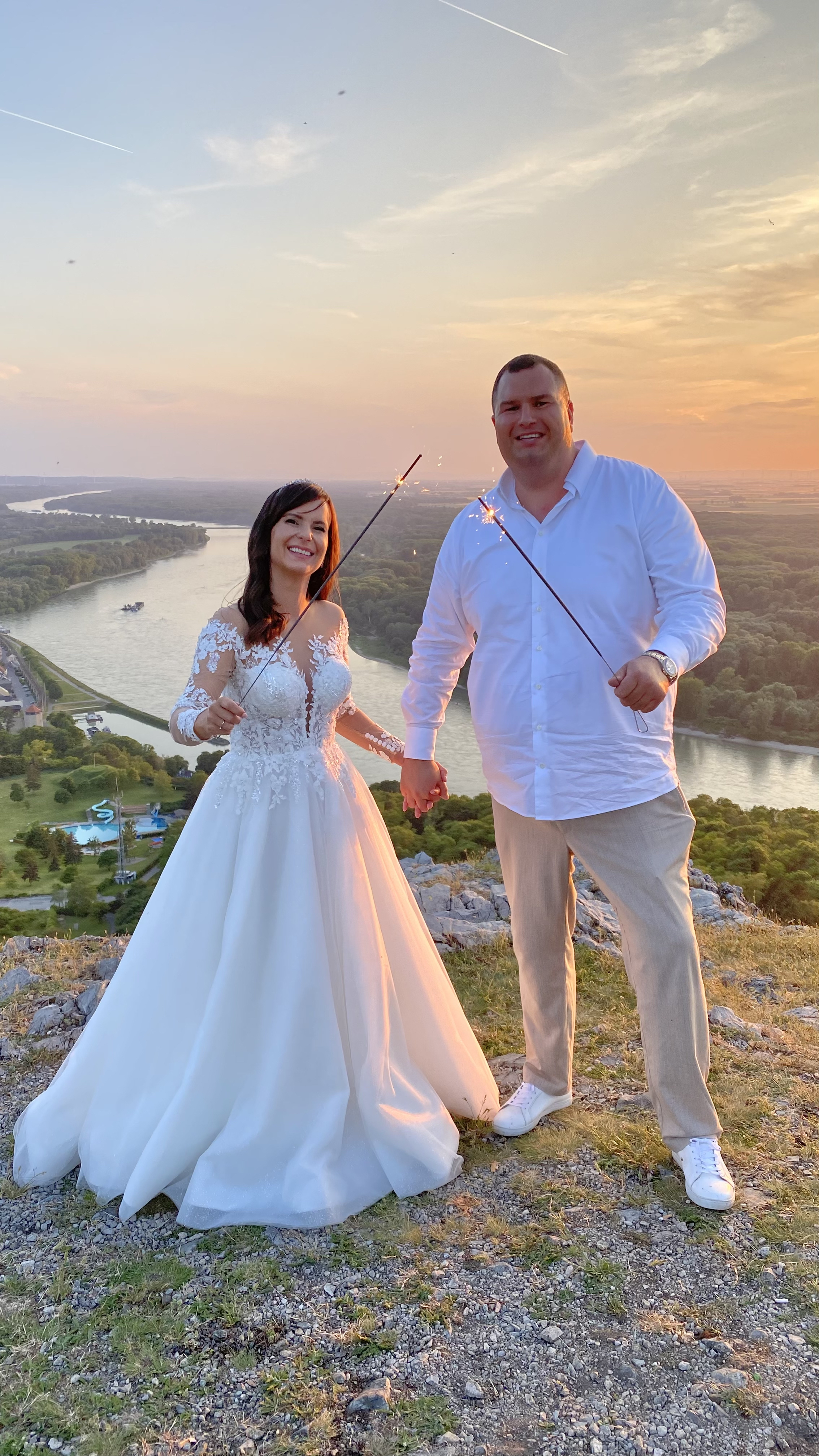bride and groom holding sparklers at sunset