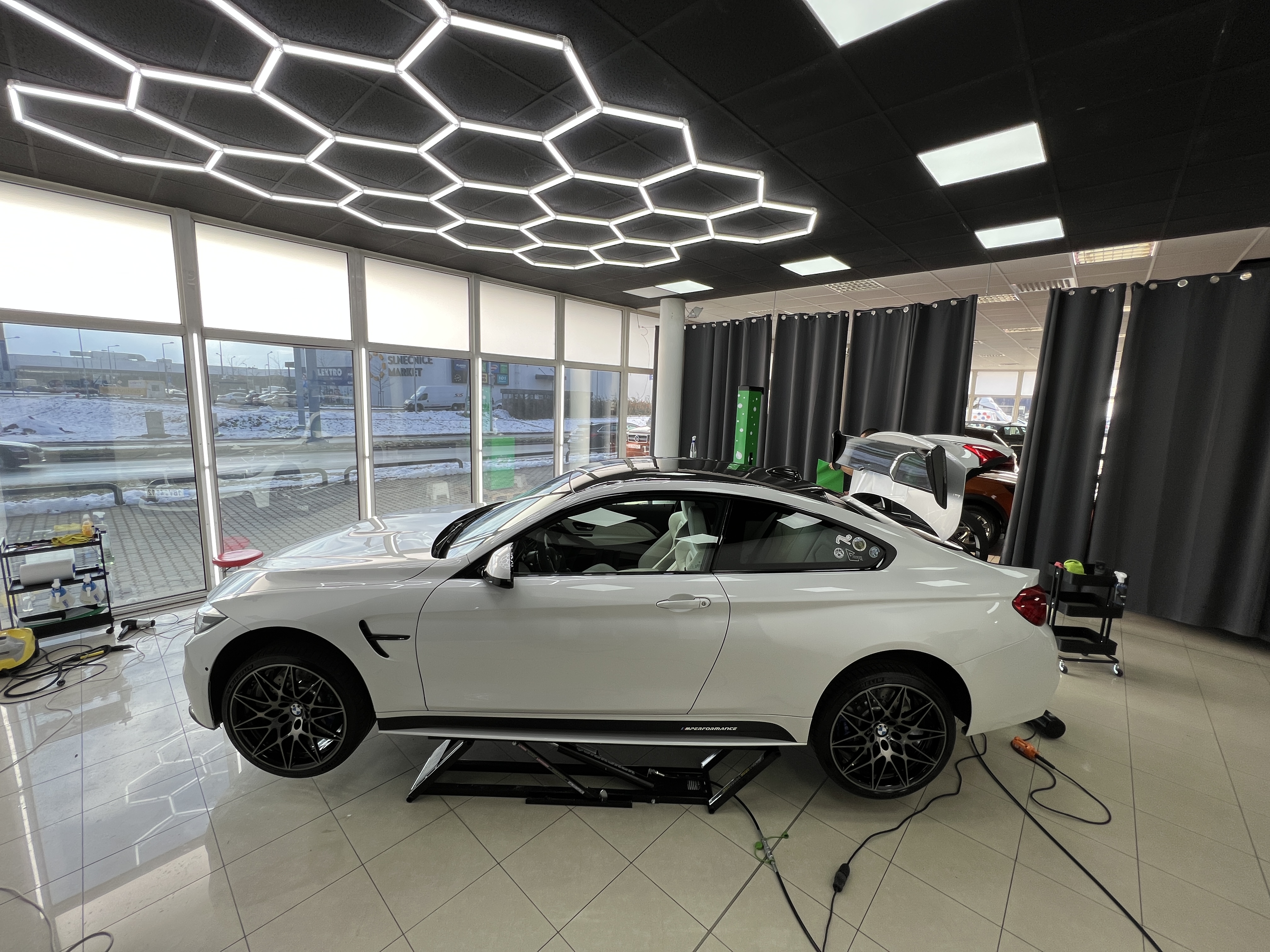 car on lift showroom