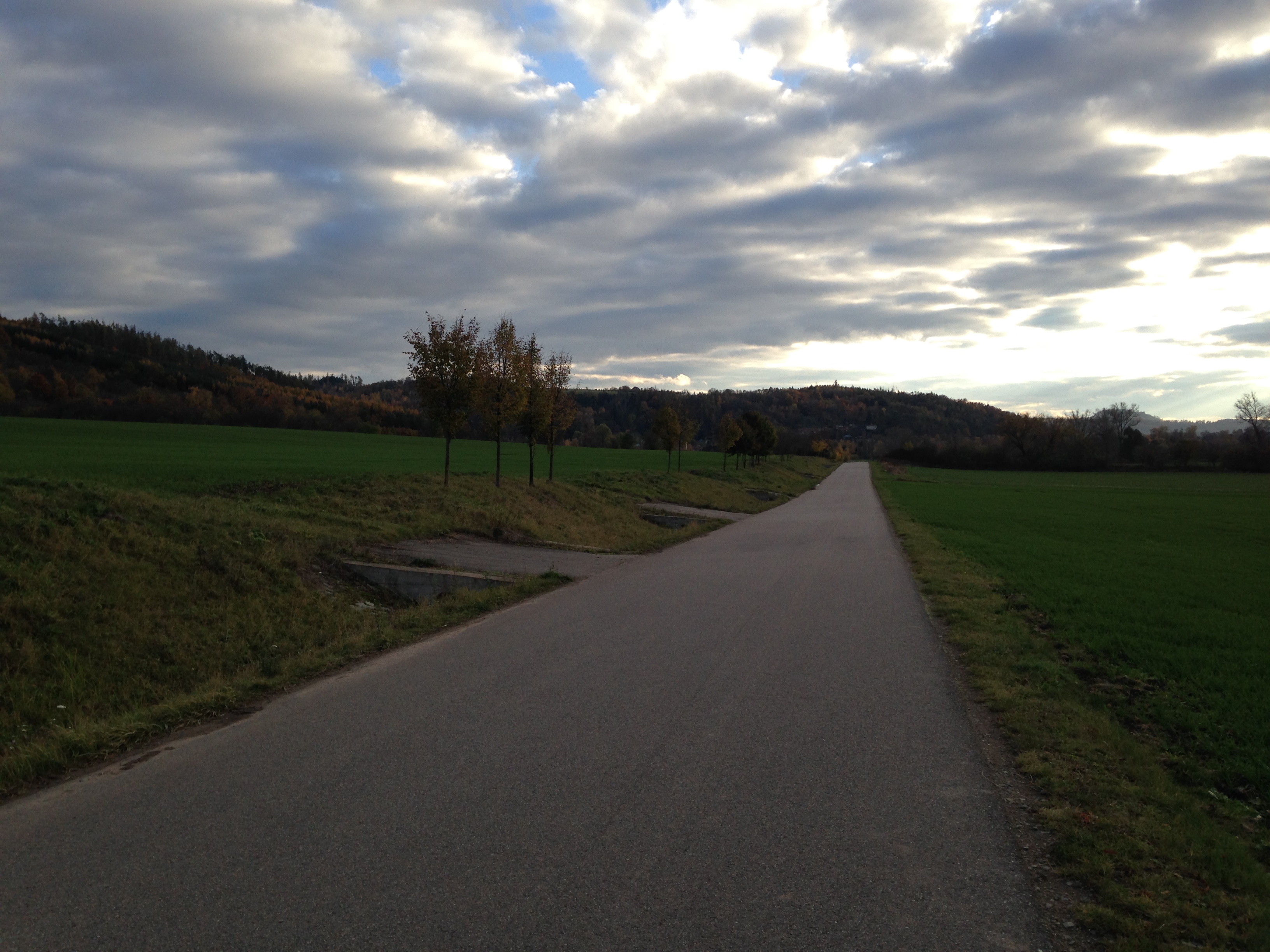 empty road under cloudy sky