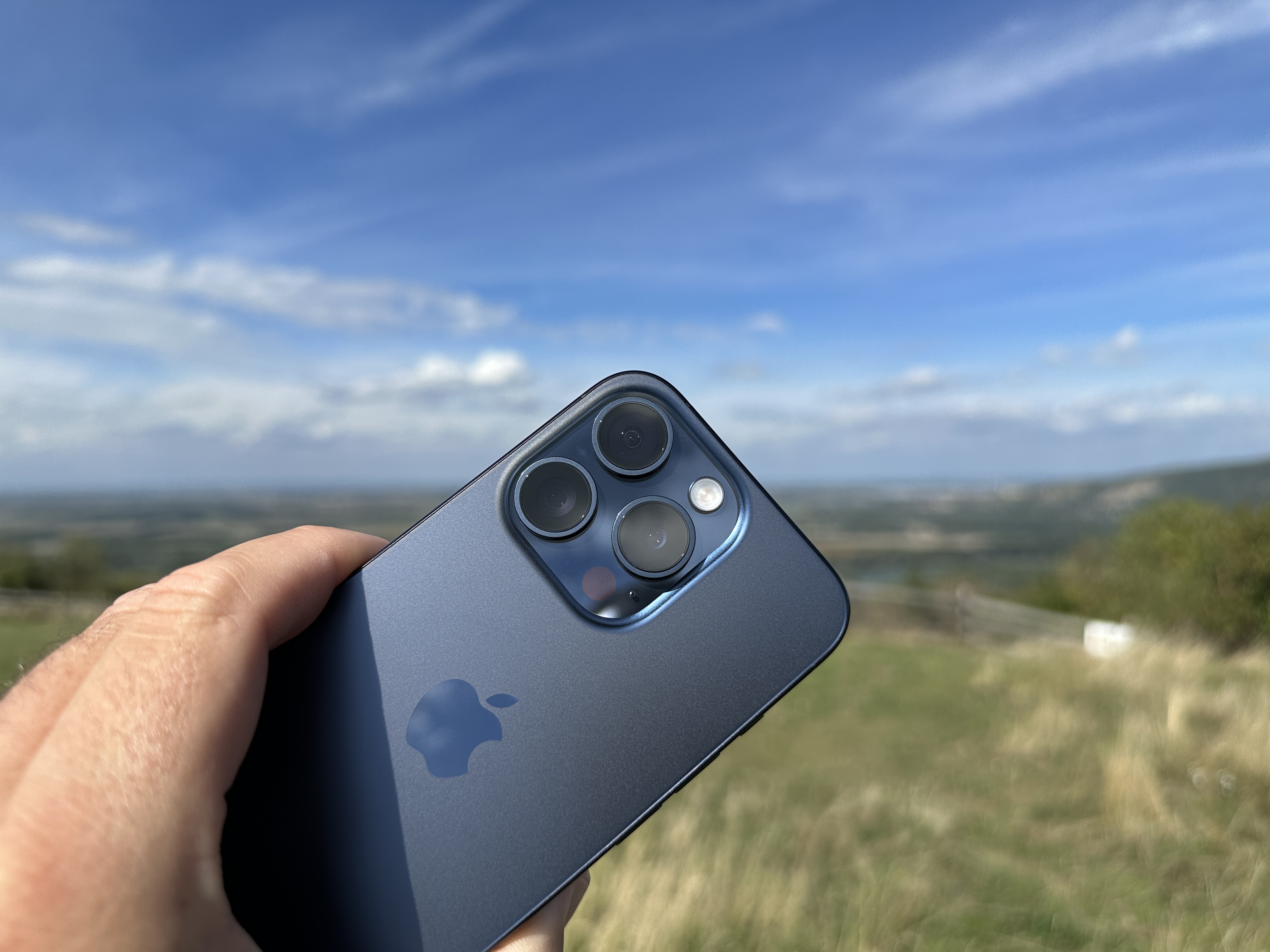 hand holding phone blue sky