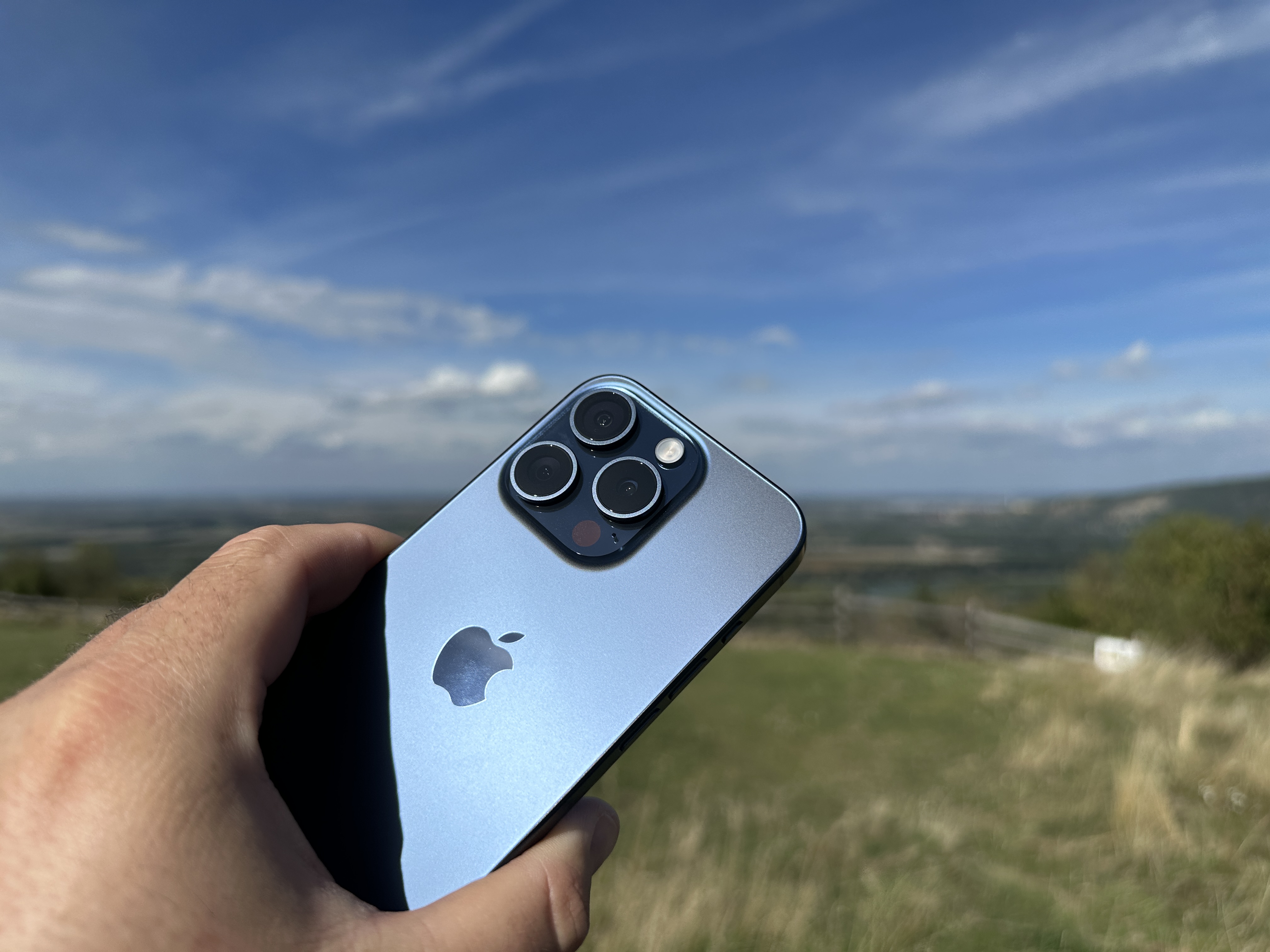 hand holding phone outdoors