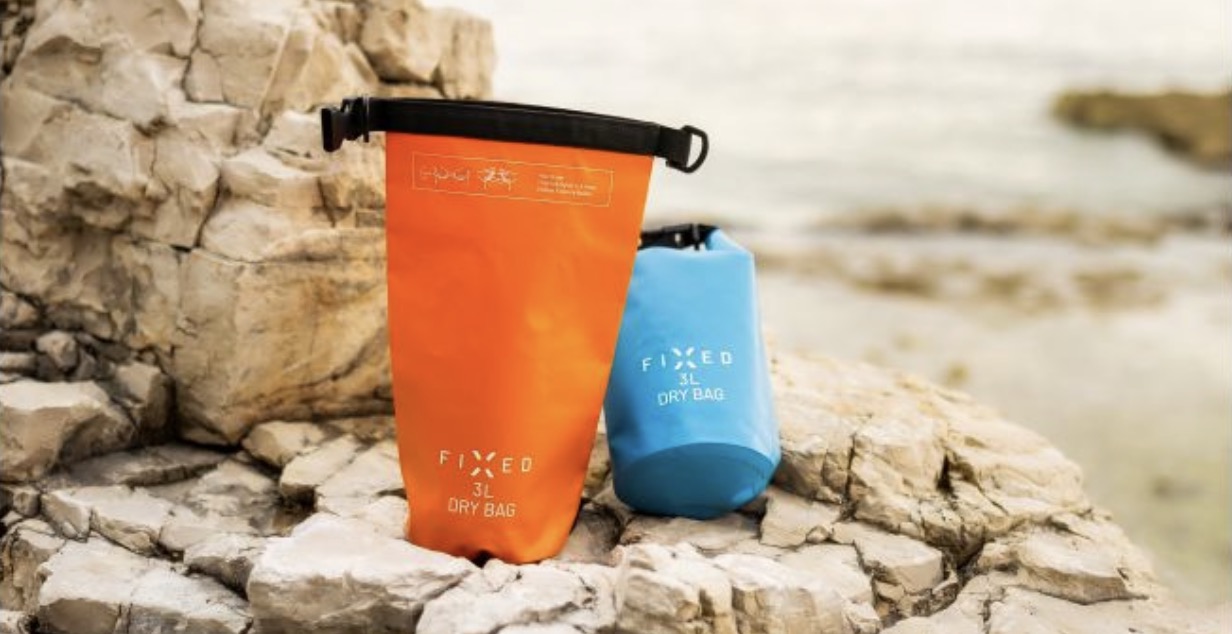 orange and blue dry bags on rocks