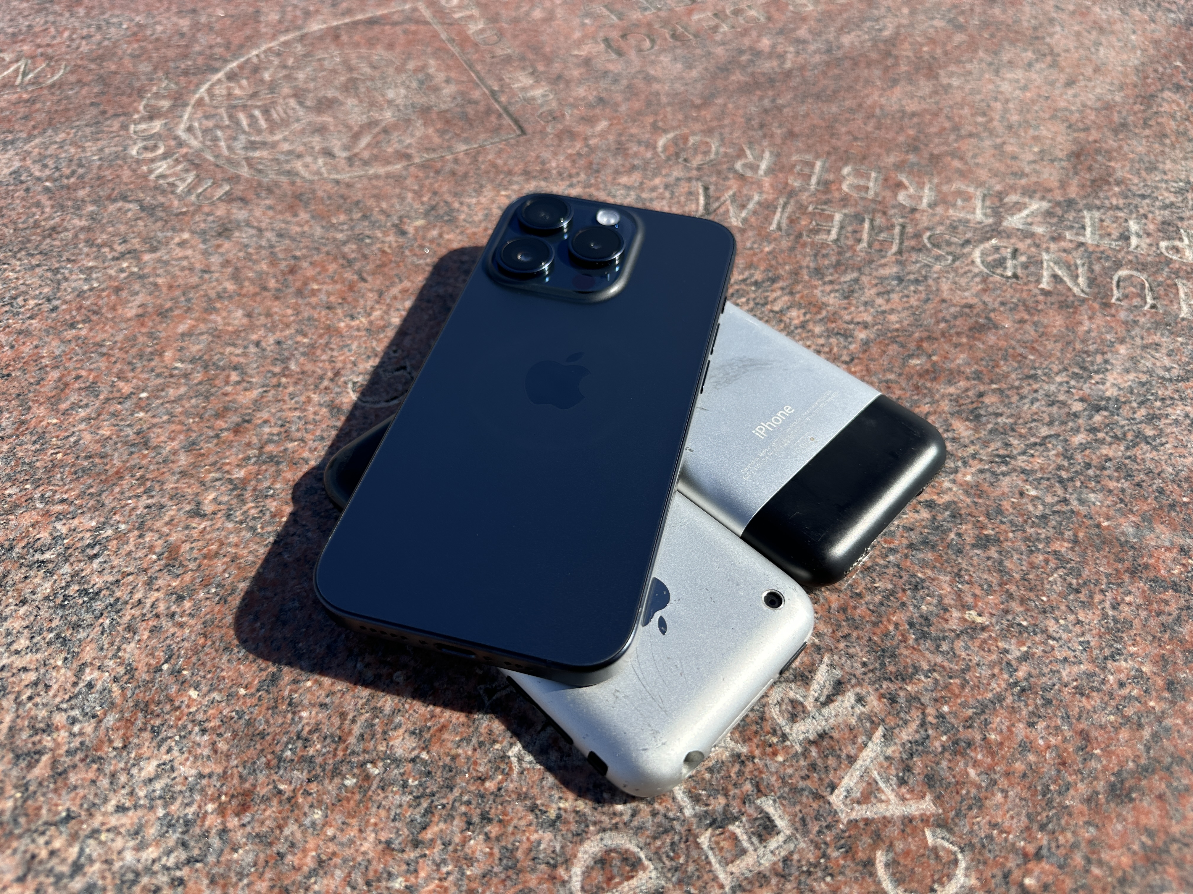 stacked iphones on stone