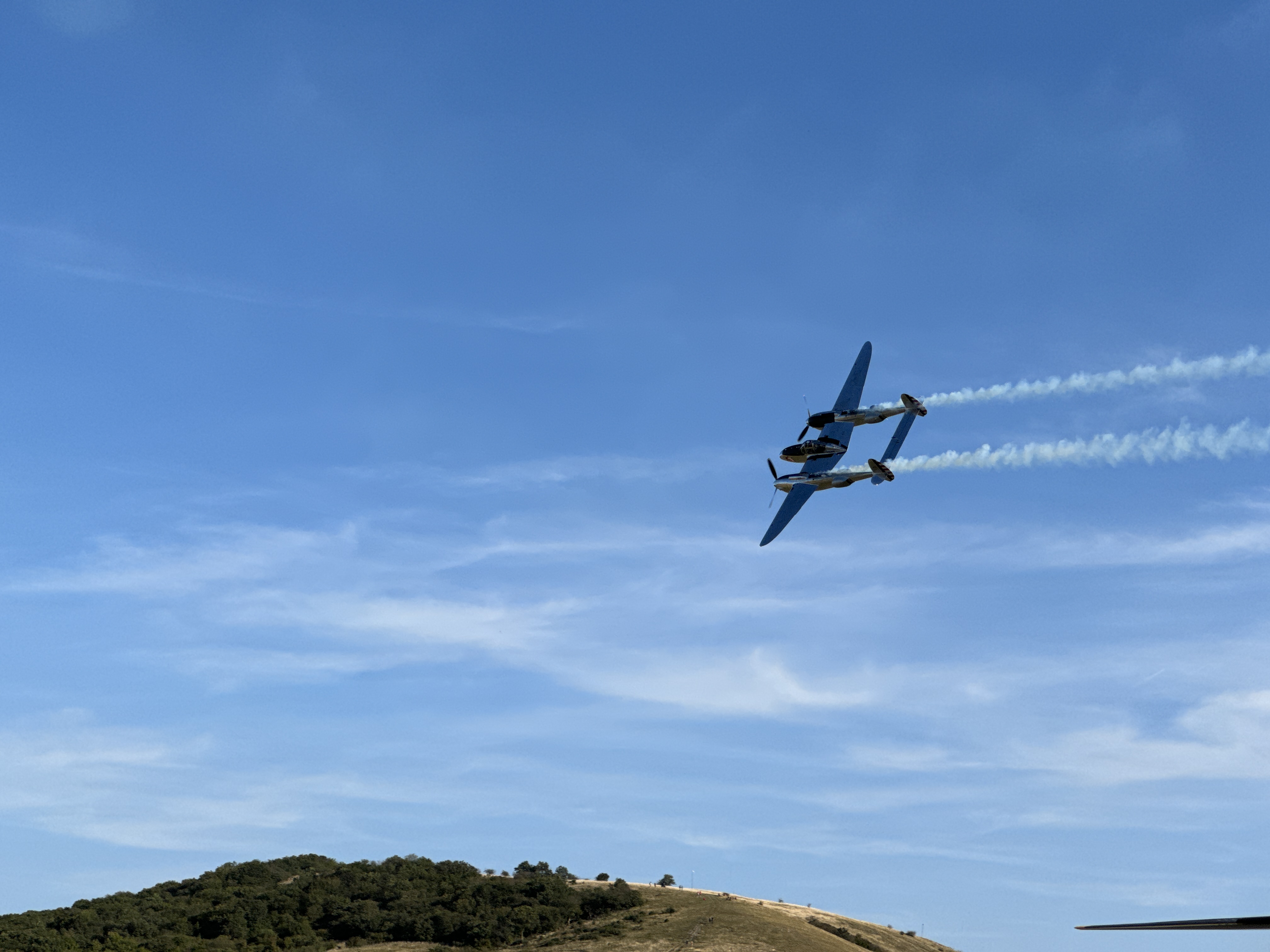 airplane flying over hill