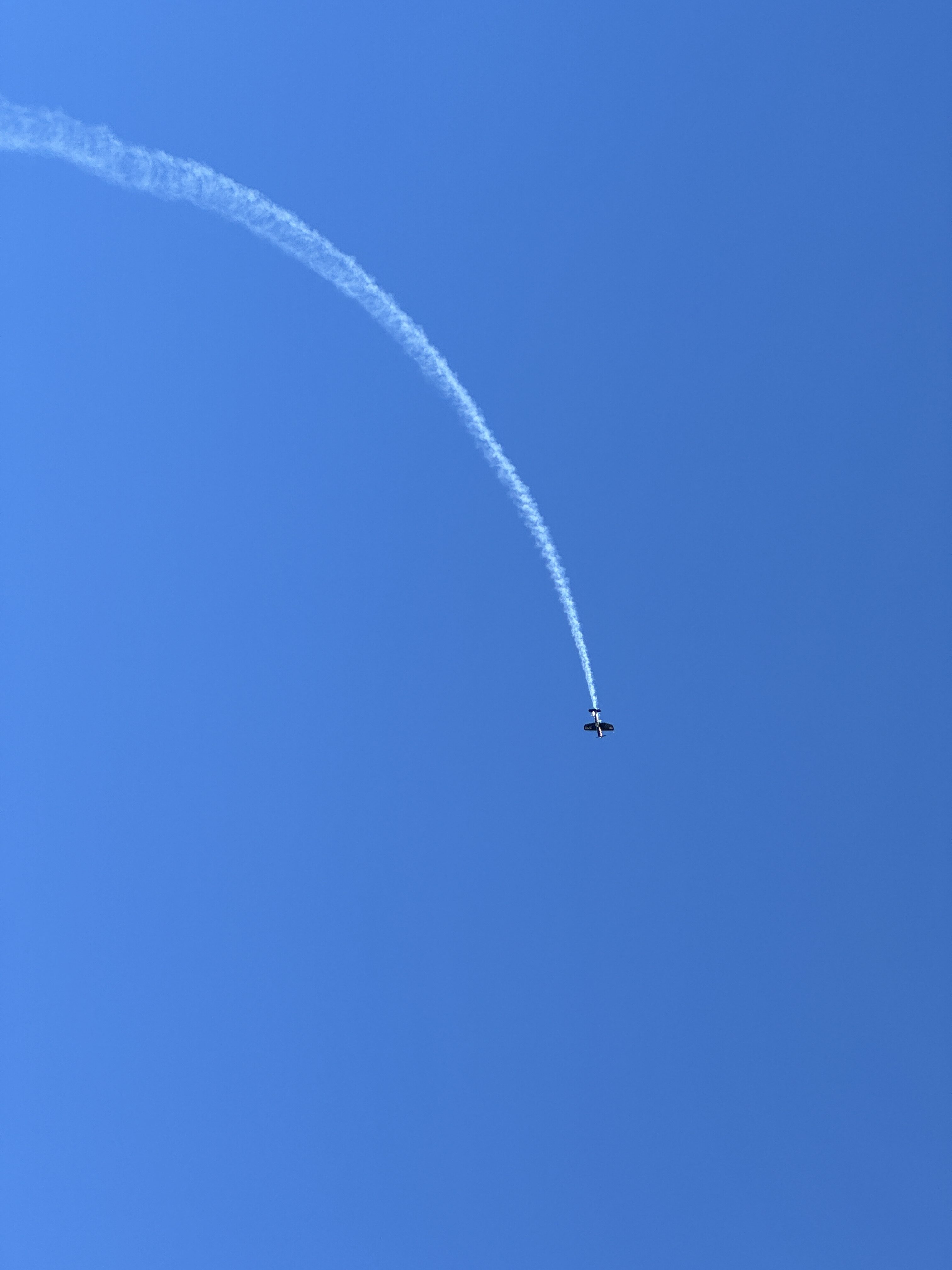 airplane looping blue sky