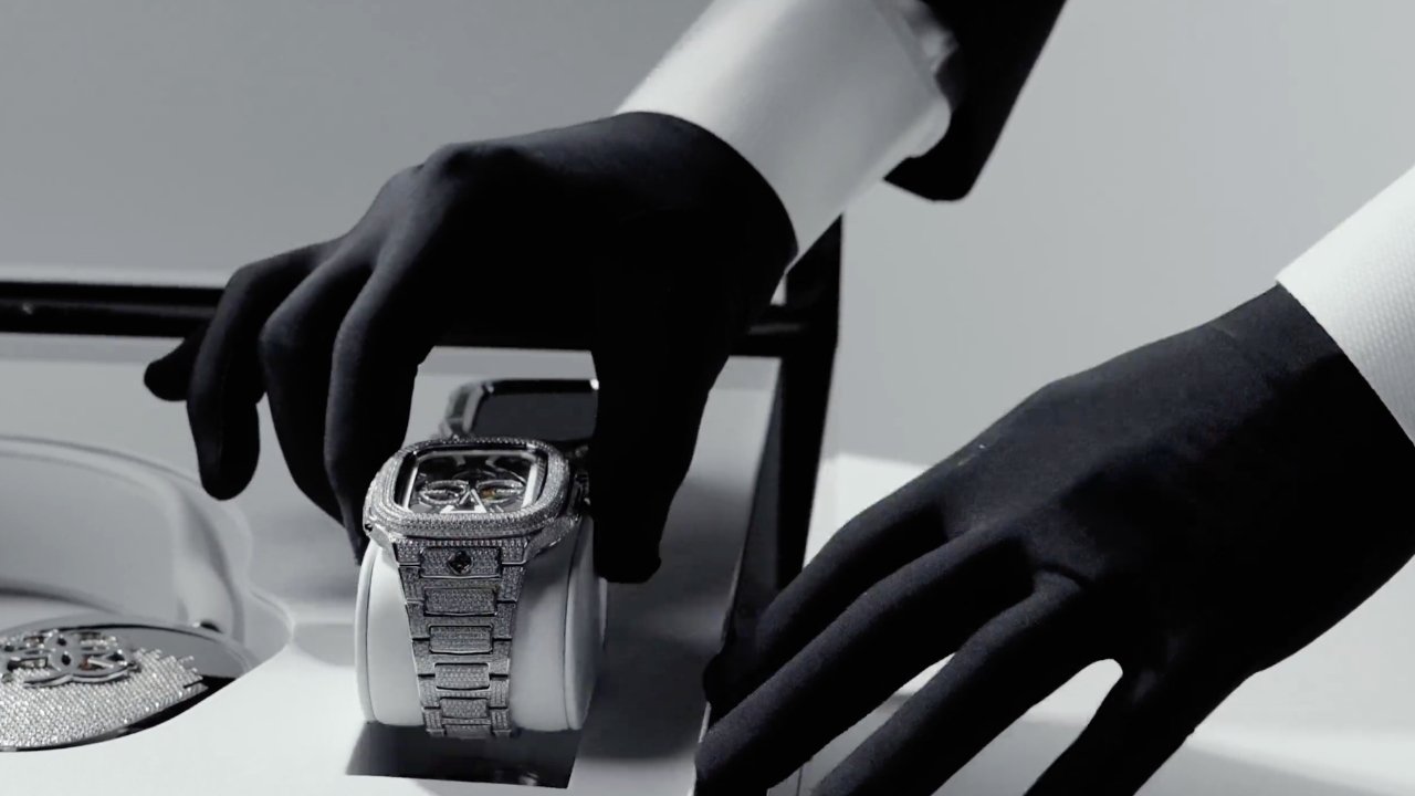 black gloves handling watch