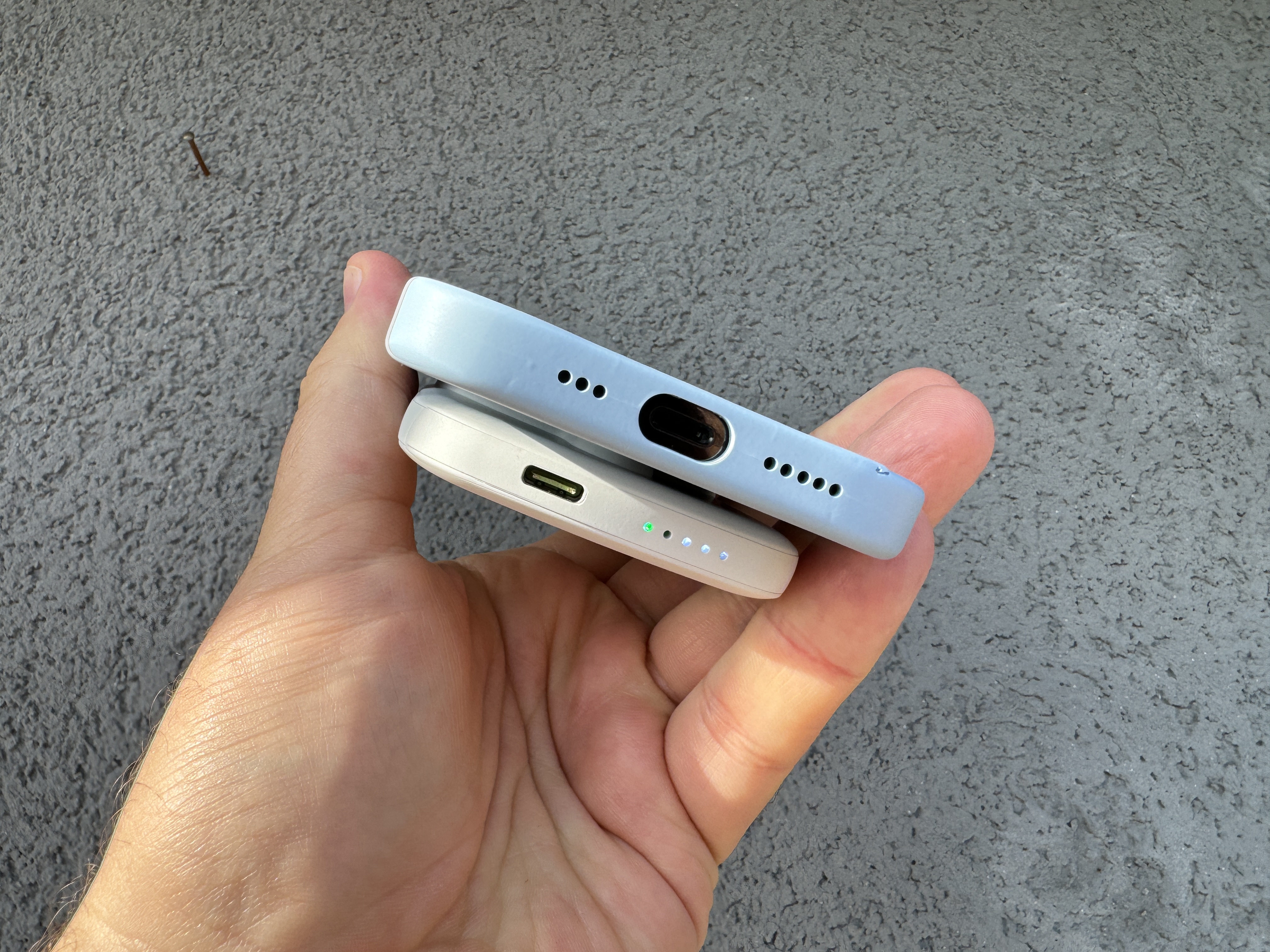 phone and battery pack on textured surface