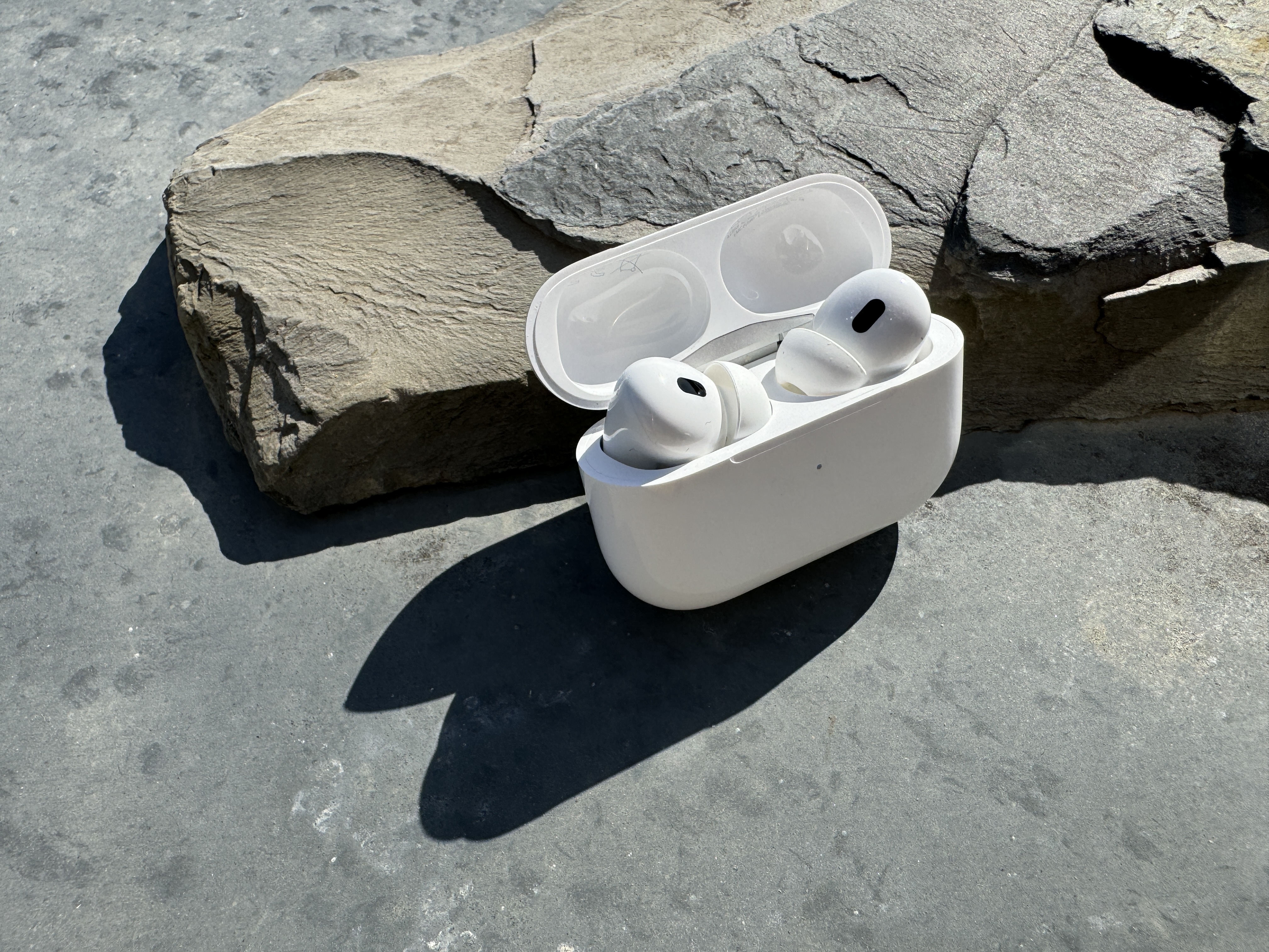 wireless earbuds on stone