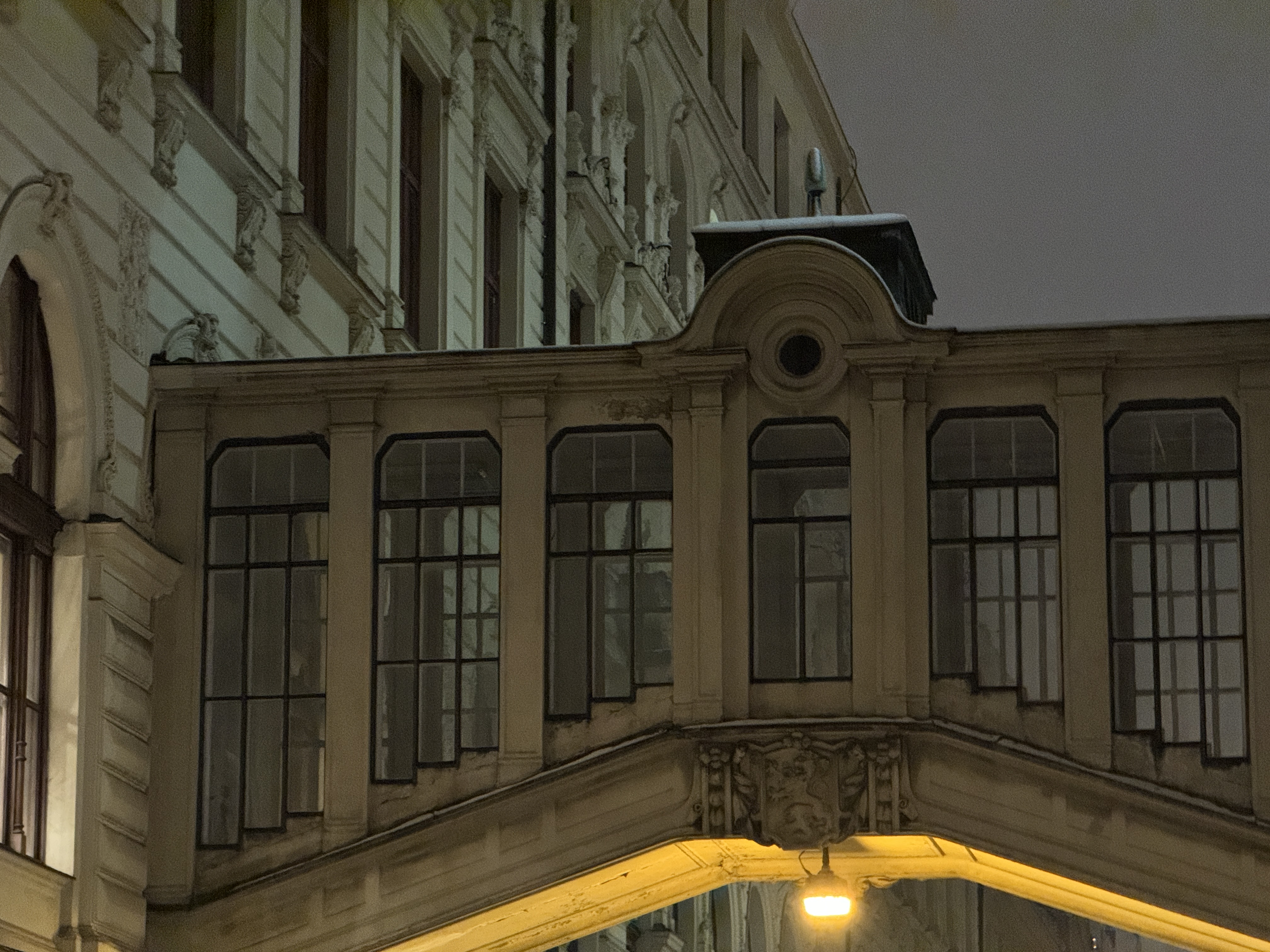 arched walkway between buildings night