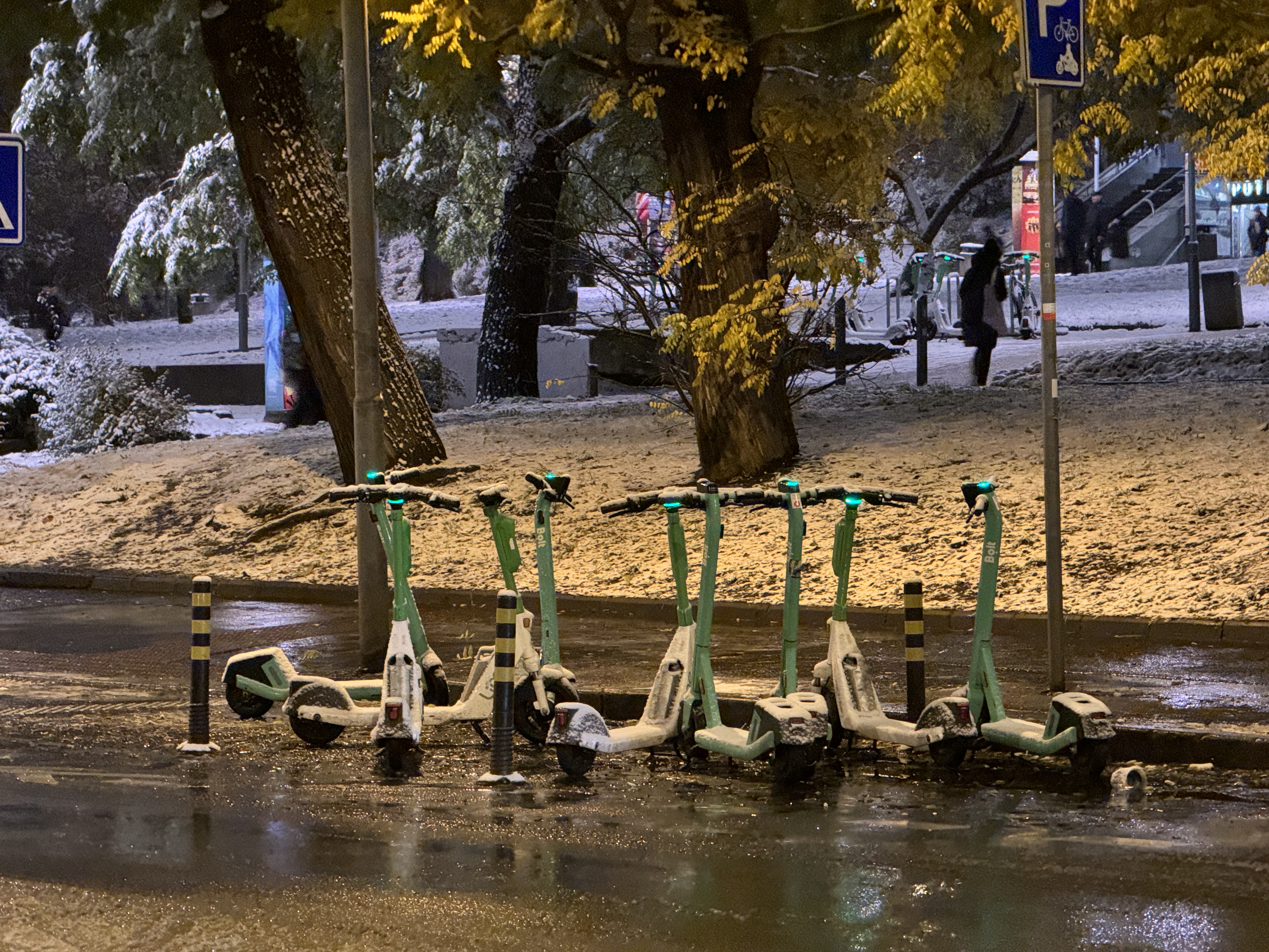 scooters parked snowy street