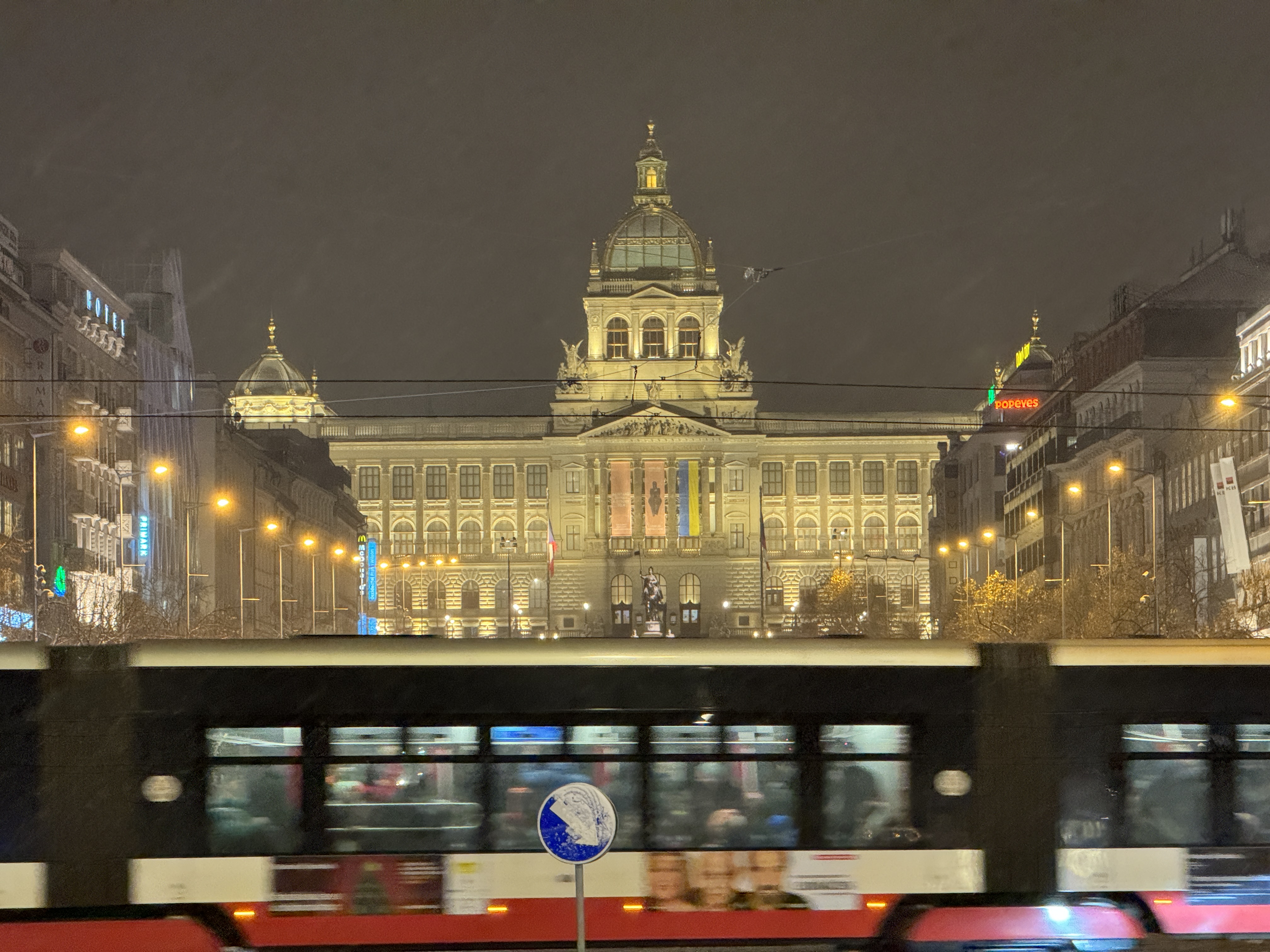 tram passing historic building night