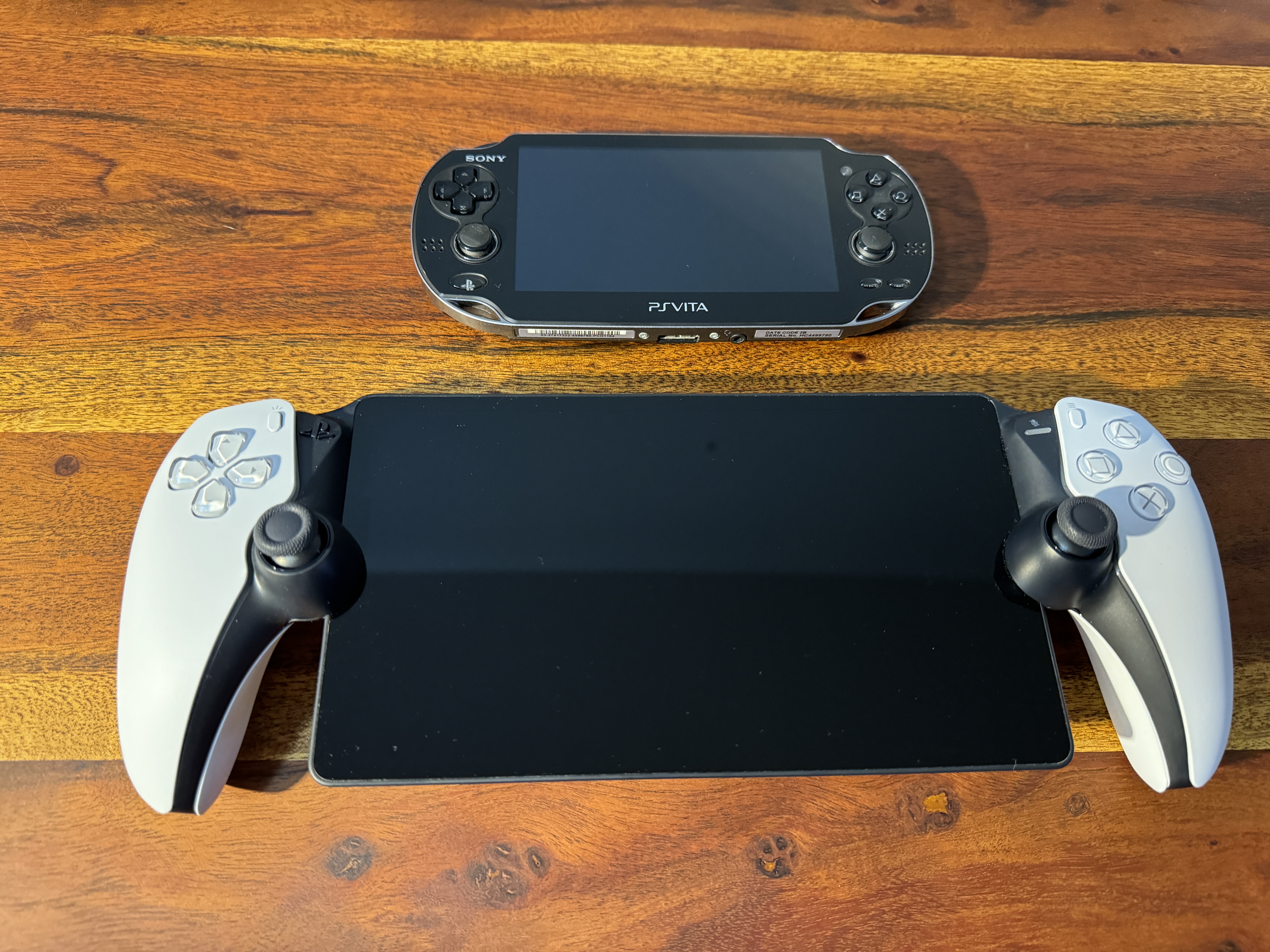 handheld gaming devices on wooden table