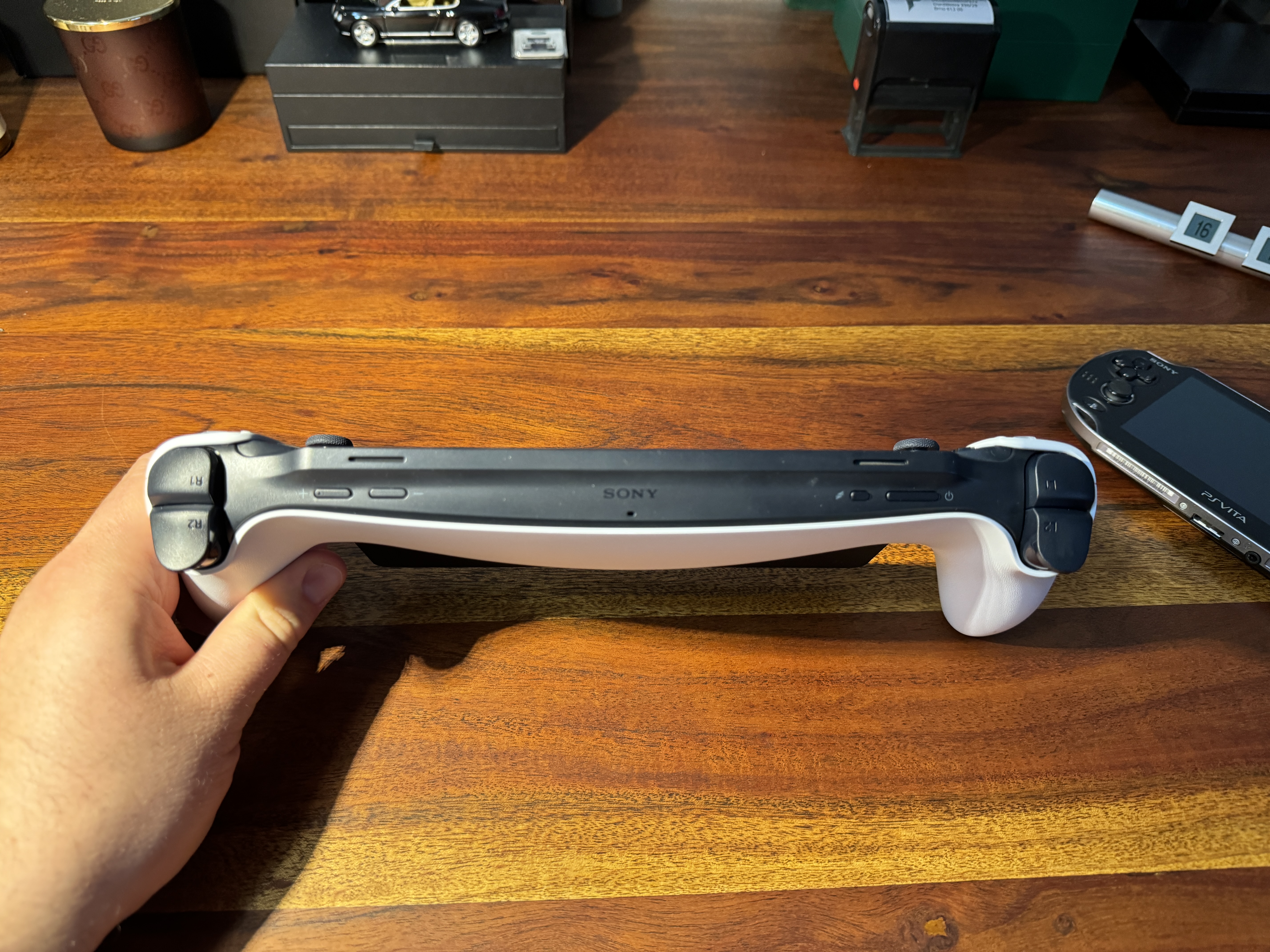 holding playstation controller on desk