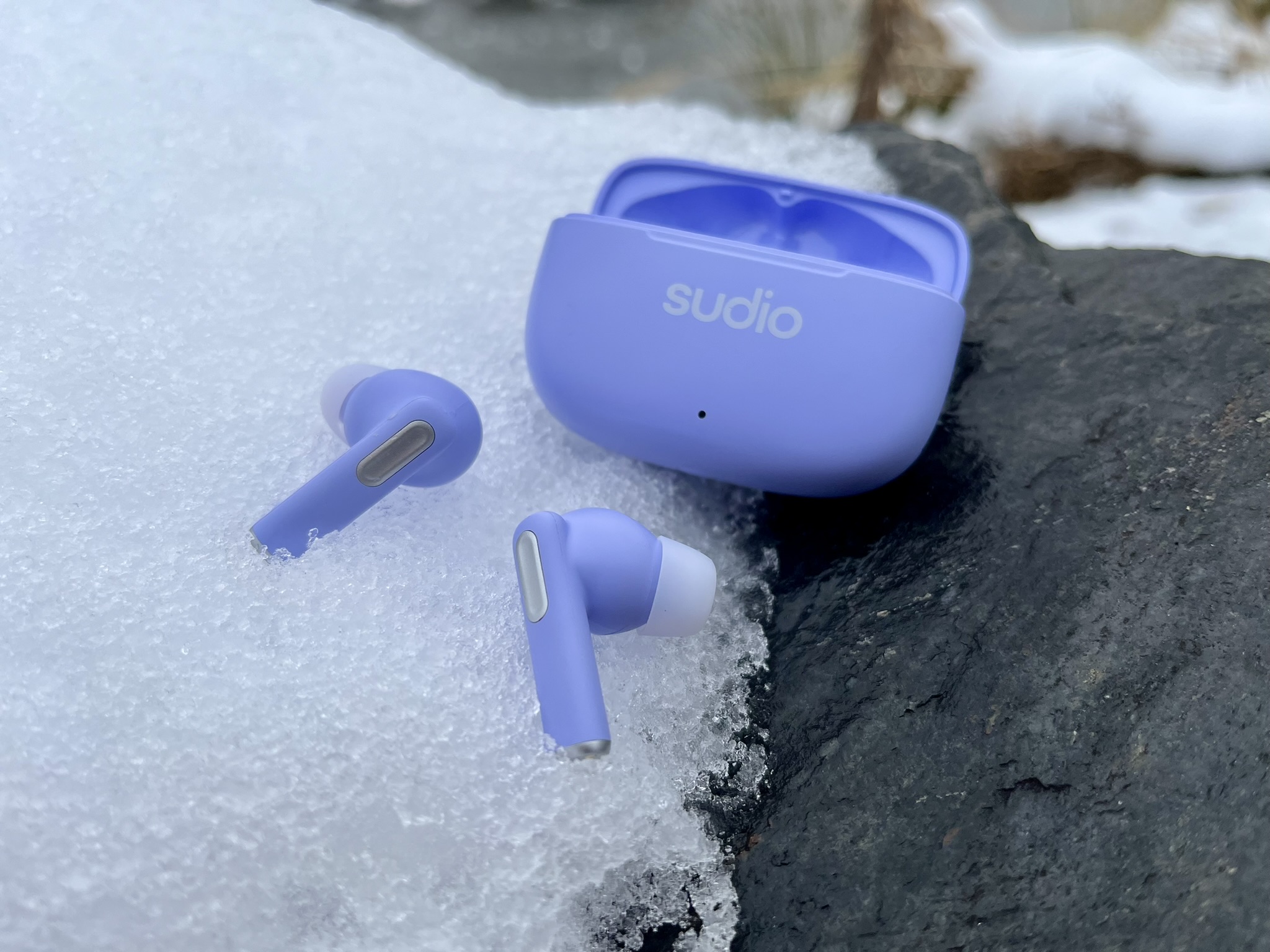 lavender earbuds on snow detail