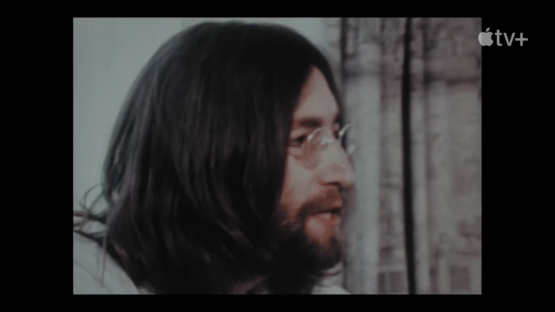 person with long hair and glasses