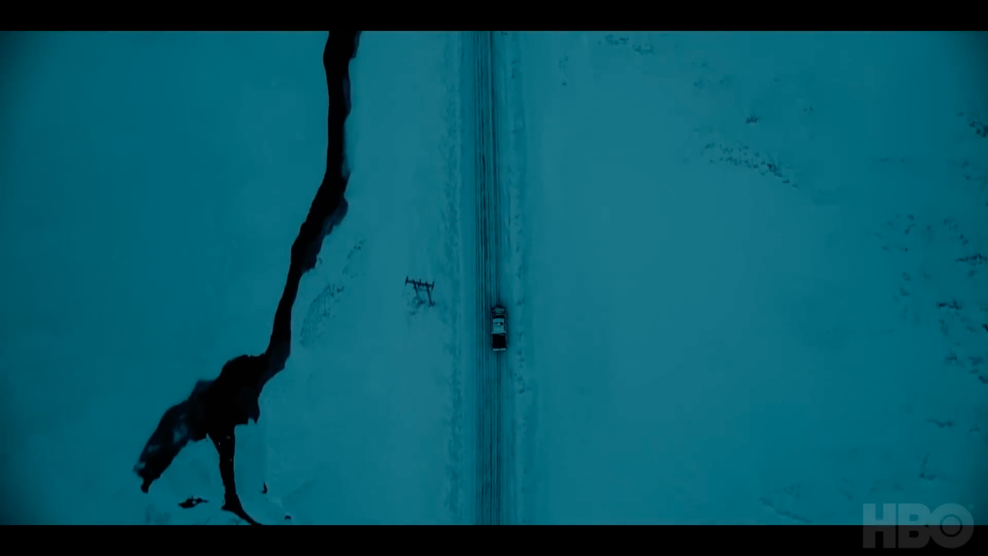 car on icy road aerial view