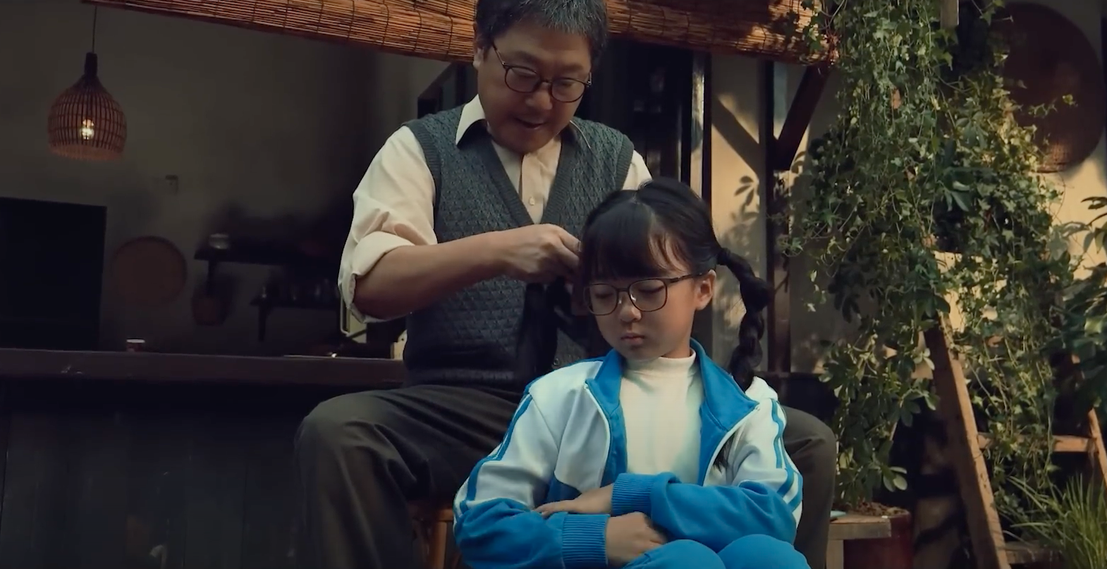 grandfather braiding girl
